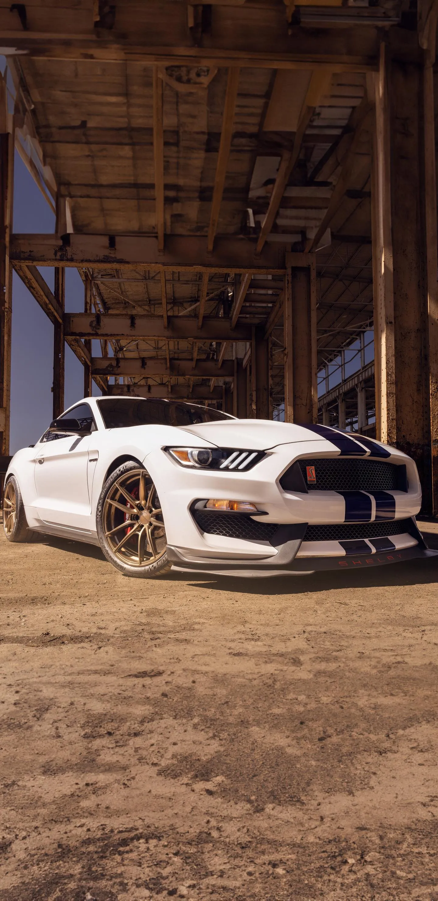 White Sports Car Parked in Rustic Warehouse Building