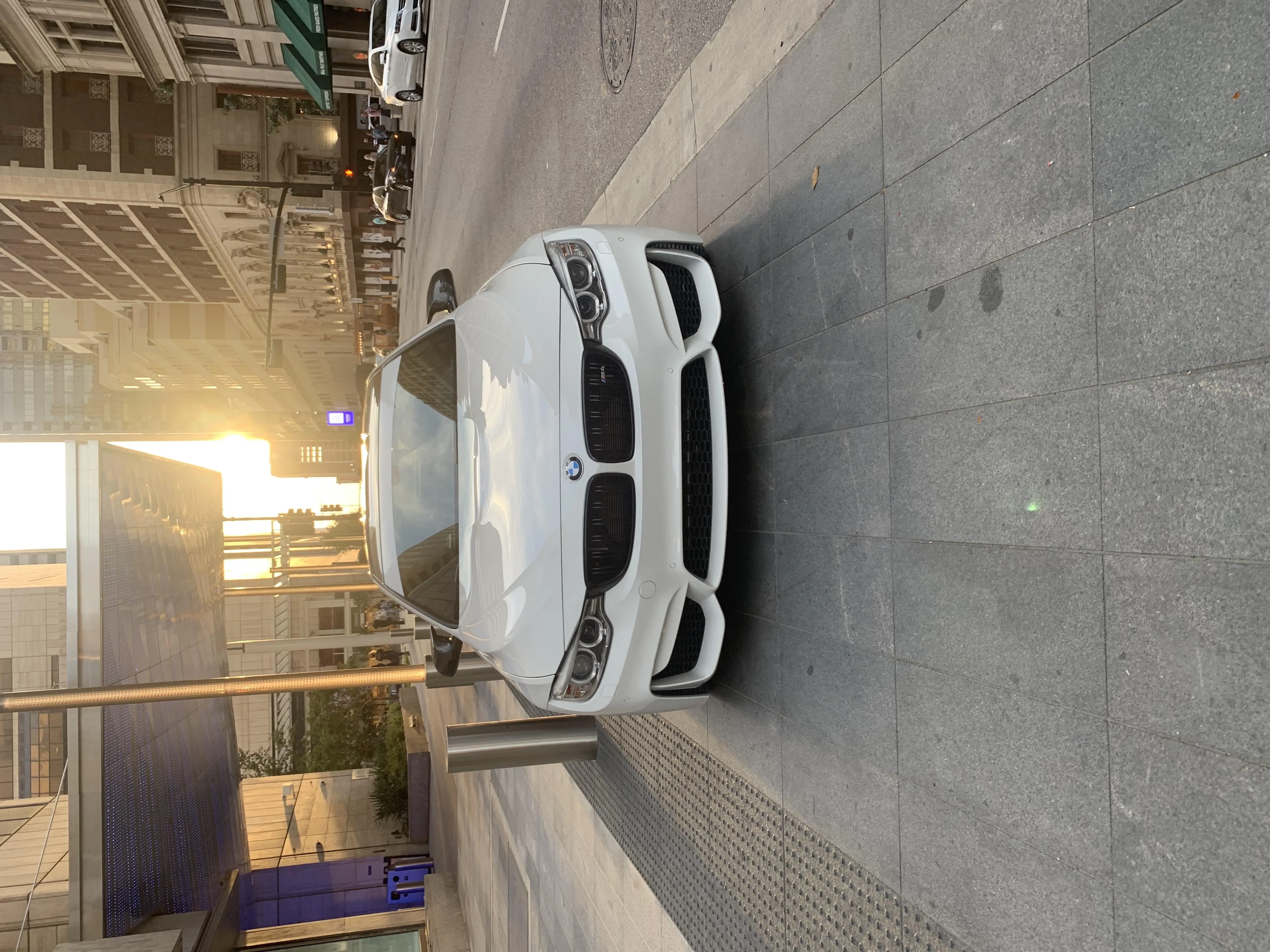 White Sports Car Parked in Urban Street at Sunset Image