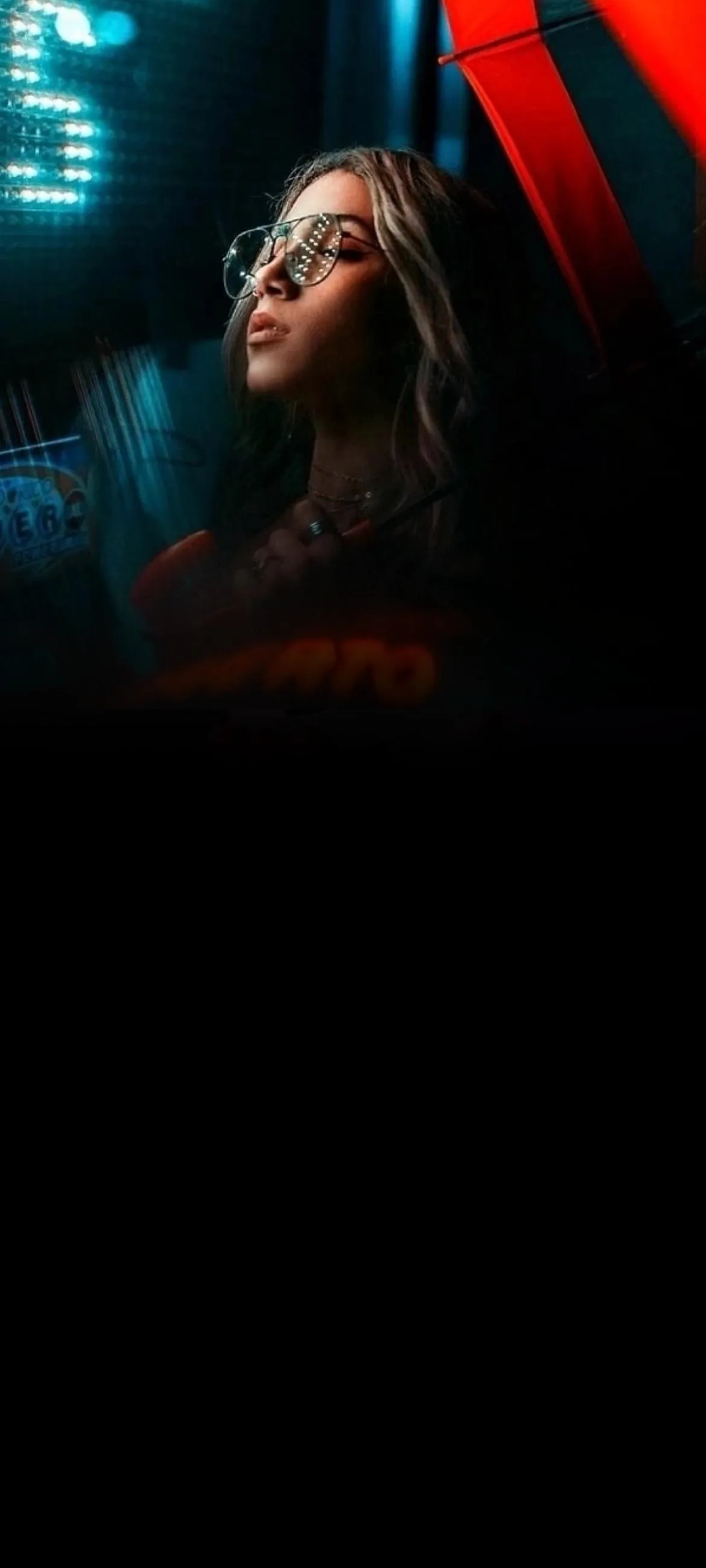 Woman in Neon Light Reflecting Urban Night Vibes Wallpaper