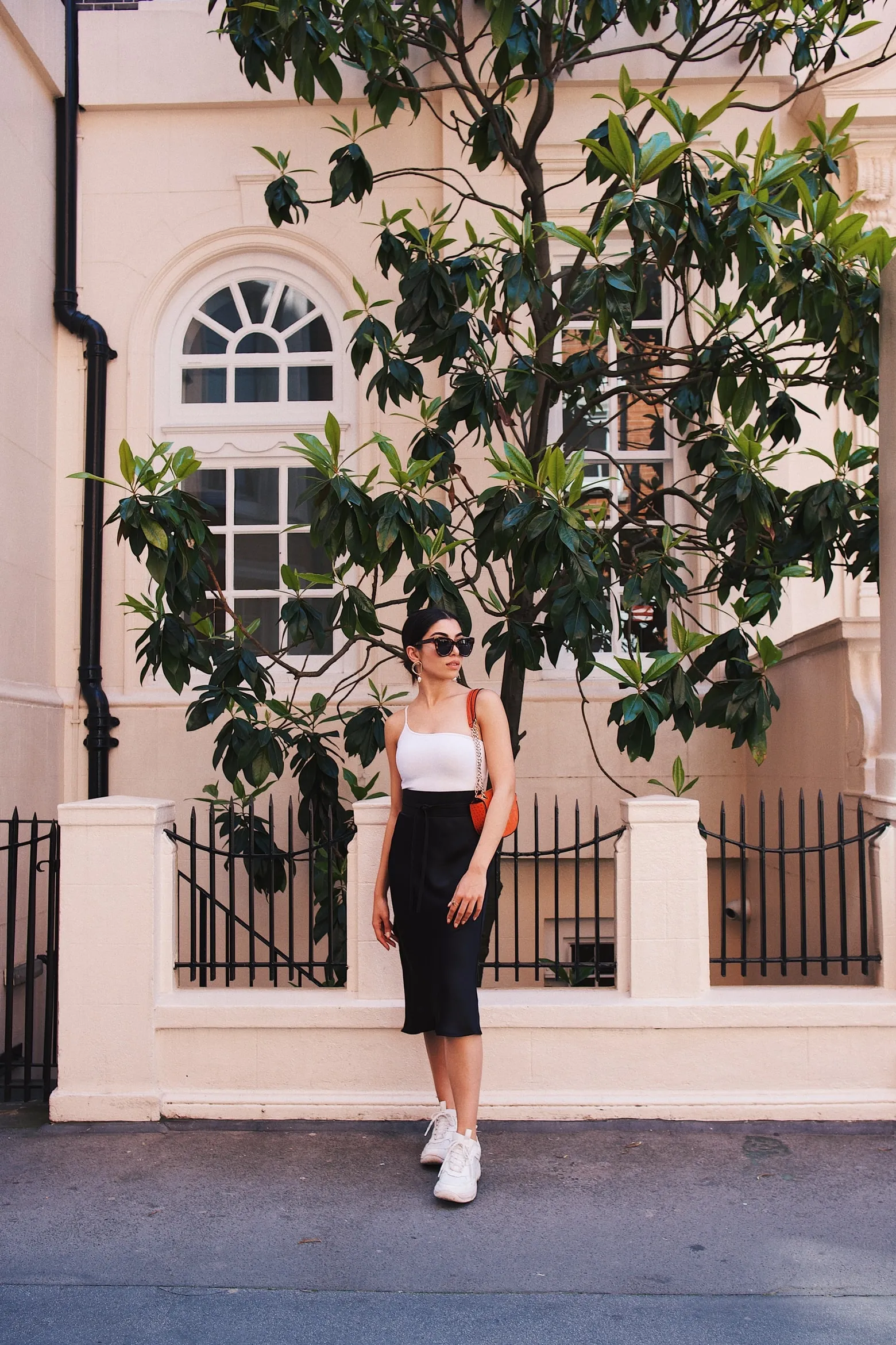 Woman Walking by Building with Flower Vines Wallpaper