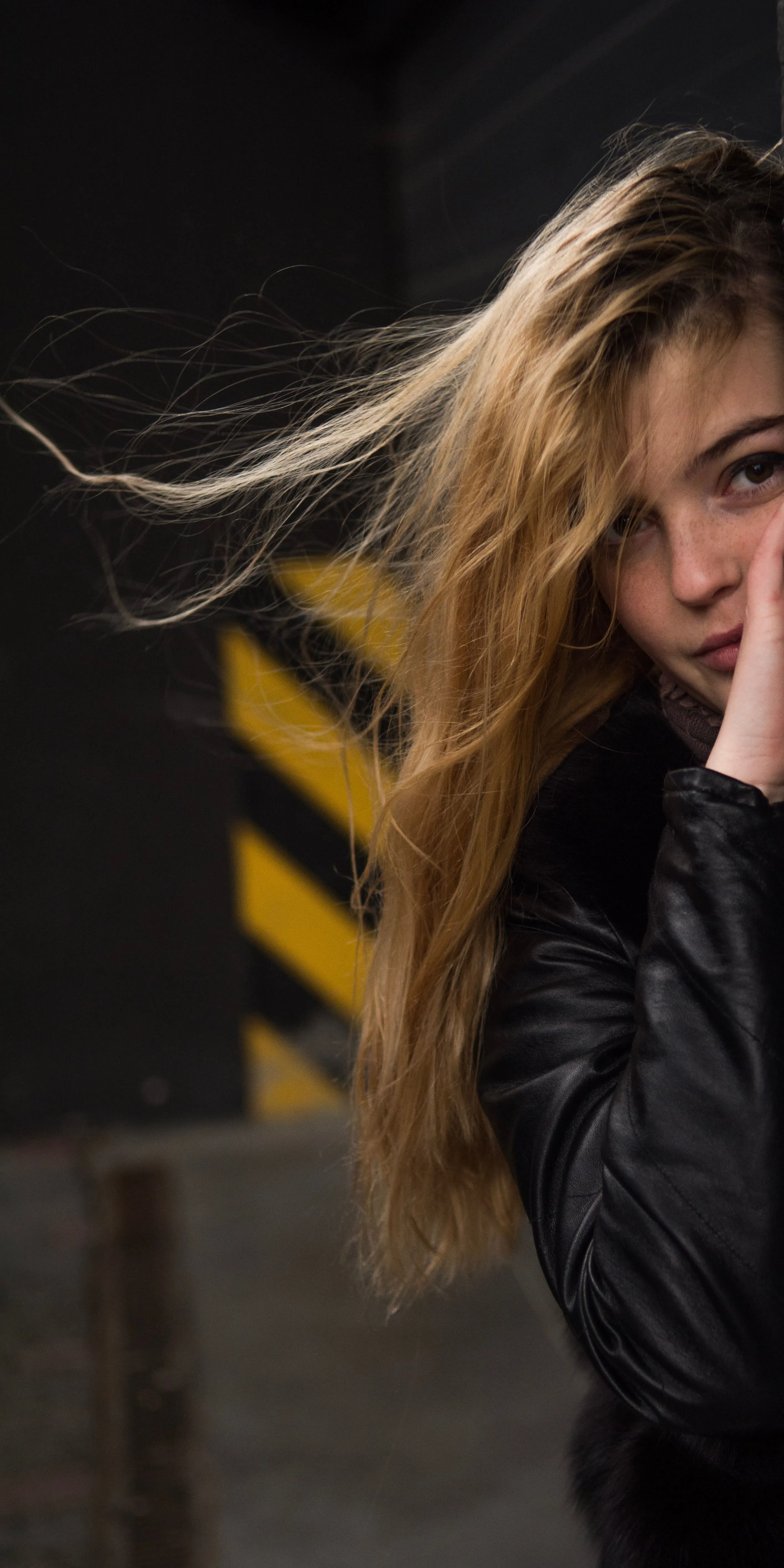 Woman with Blonde Hair Standing in Urban Alley Wallpaper