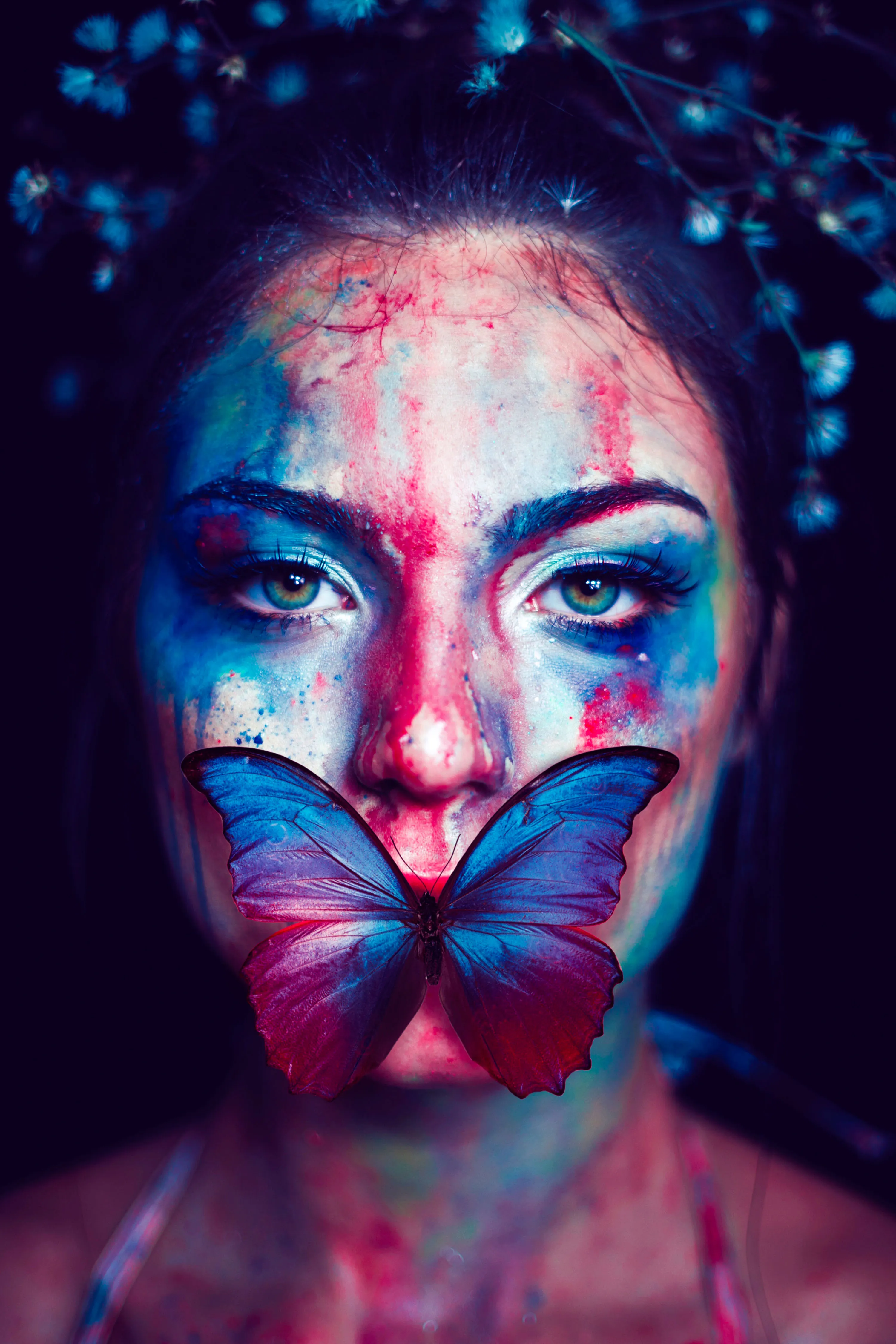 Woman with Butterfly Face Paint in Dramatic Lighting