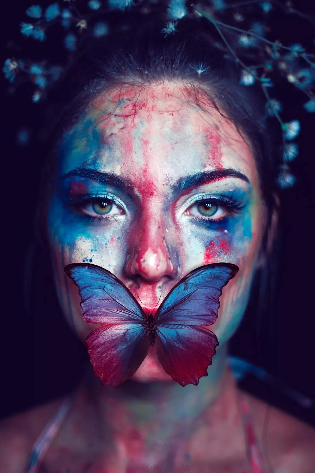 Woman with Painted Face Staring under Dramatic Lighting