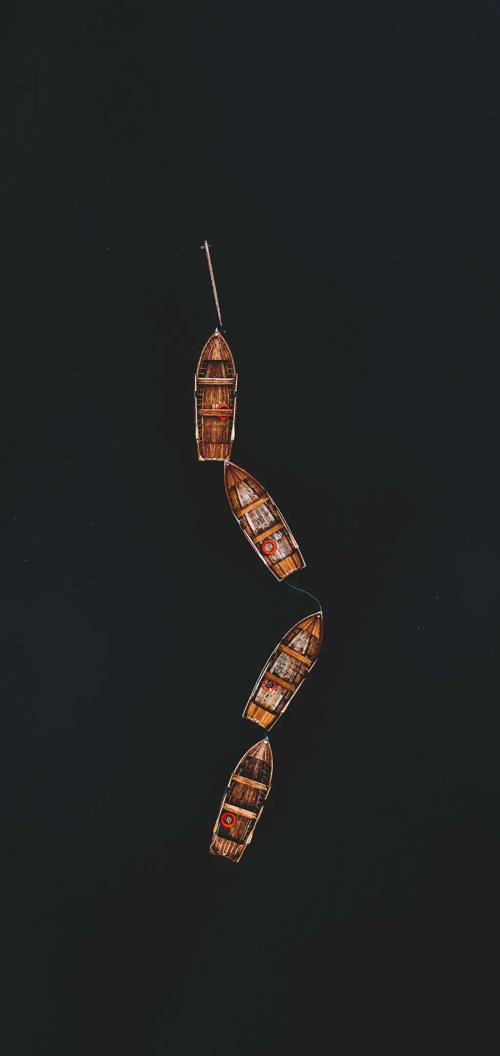 Wooden Boats Aligned Peacefully on Still Dark Water