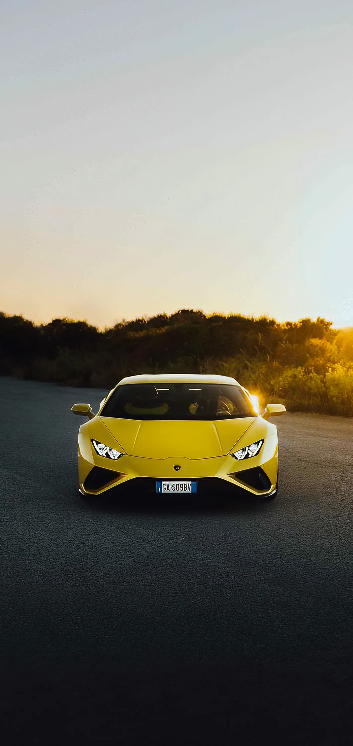Yellow Sports Car on Desert Road During Sunset Wallpaper