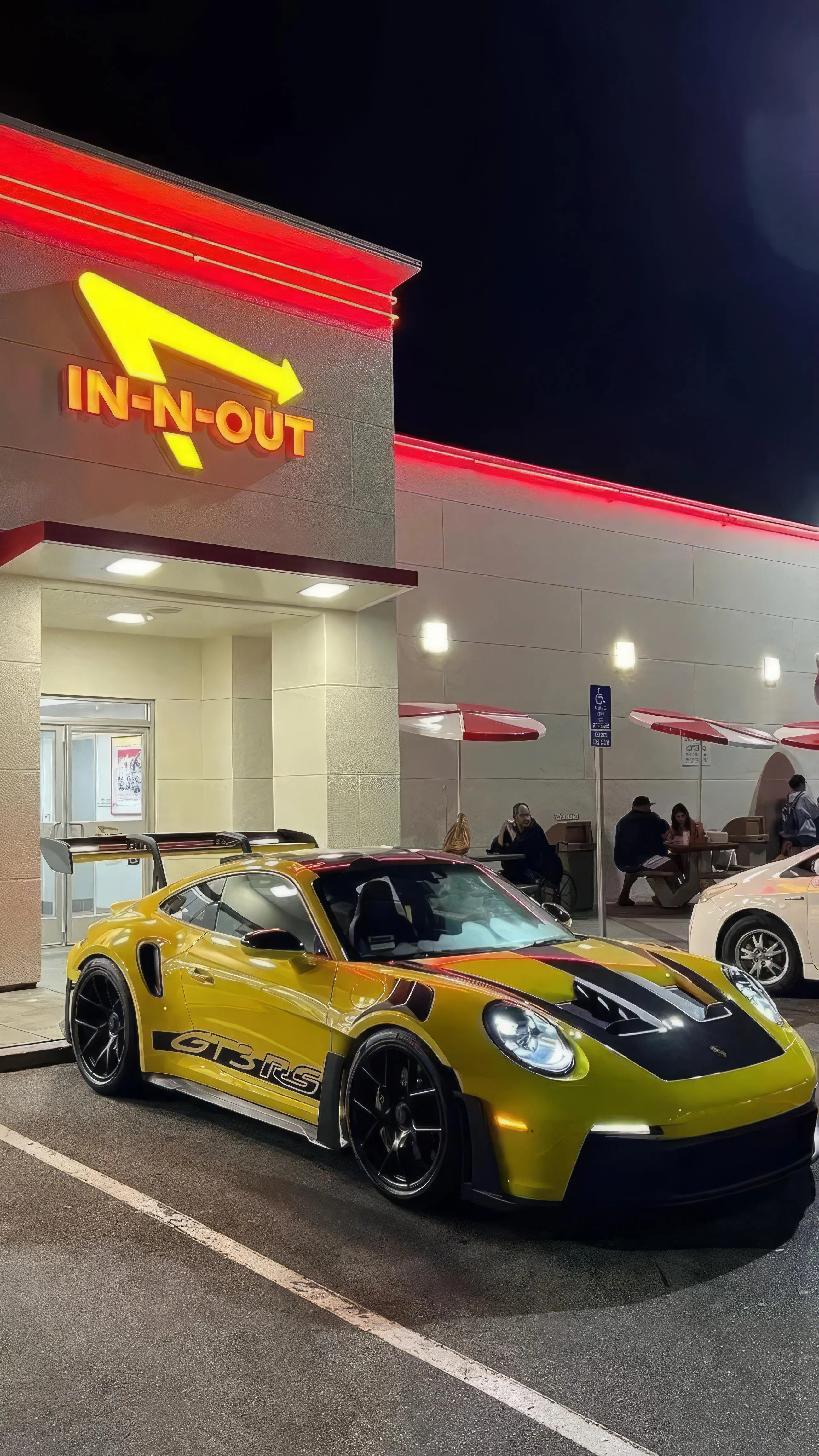 Yellow Sports Car Parked at Nighttime Gas Station Image