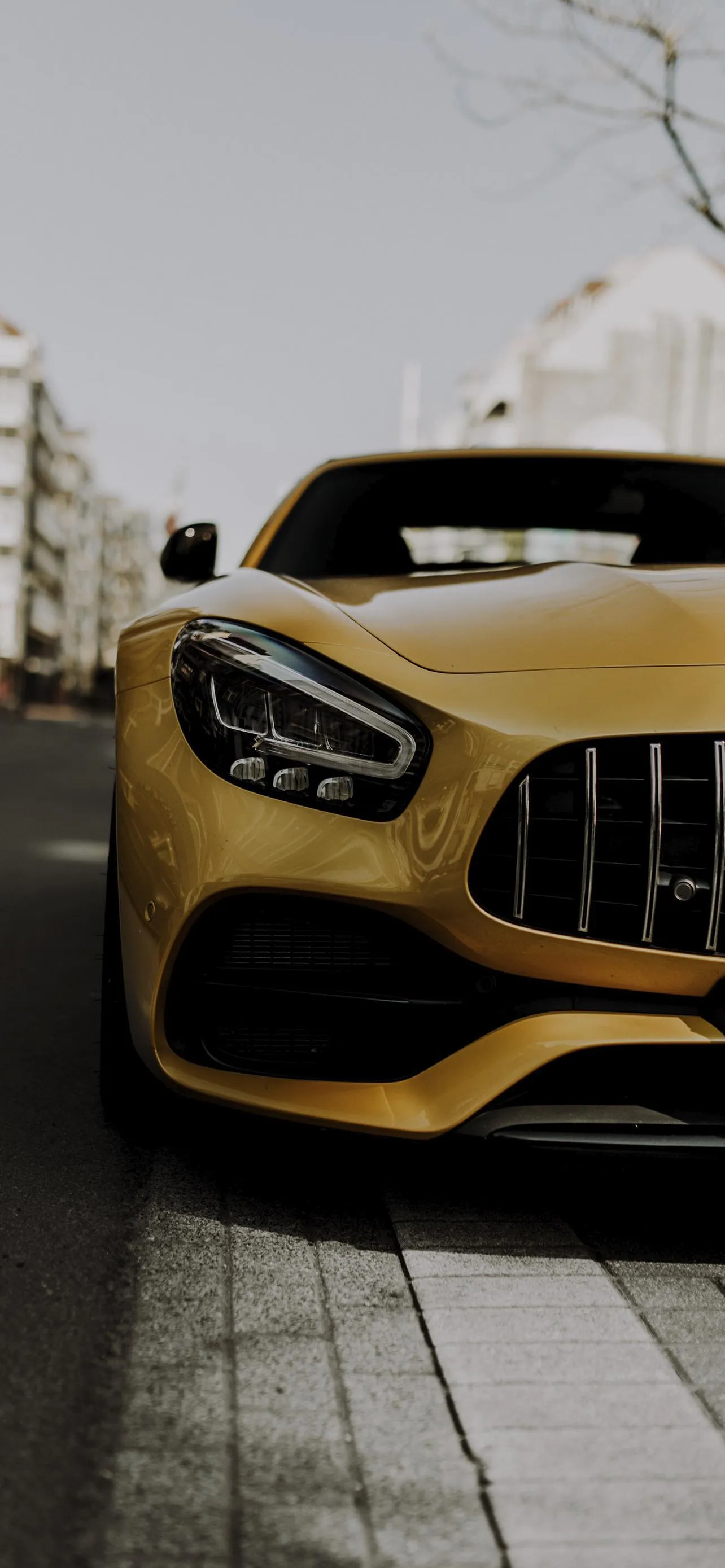 Yellow Sports Car Parked on Modern Urban Street Wallpaper