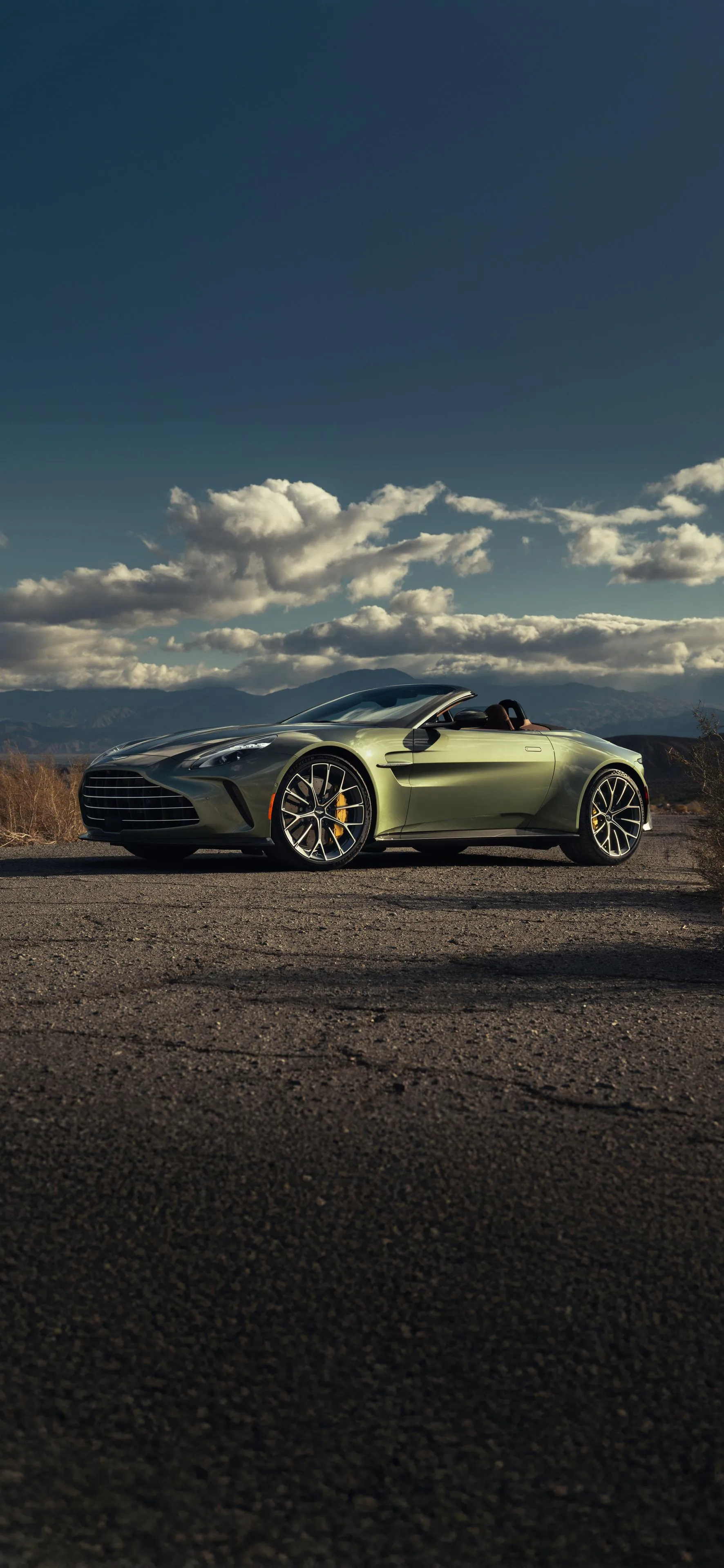 Yellow Sports Car Parked on Road with Cloudy Sky Wallpaper