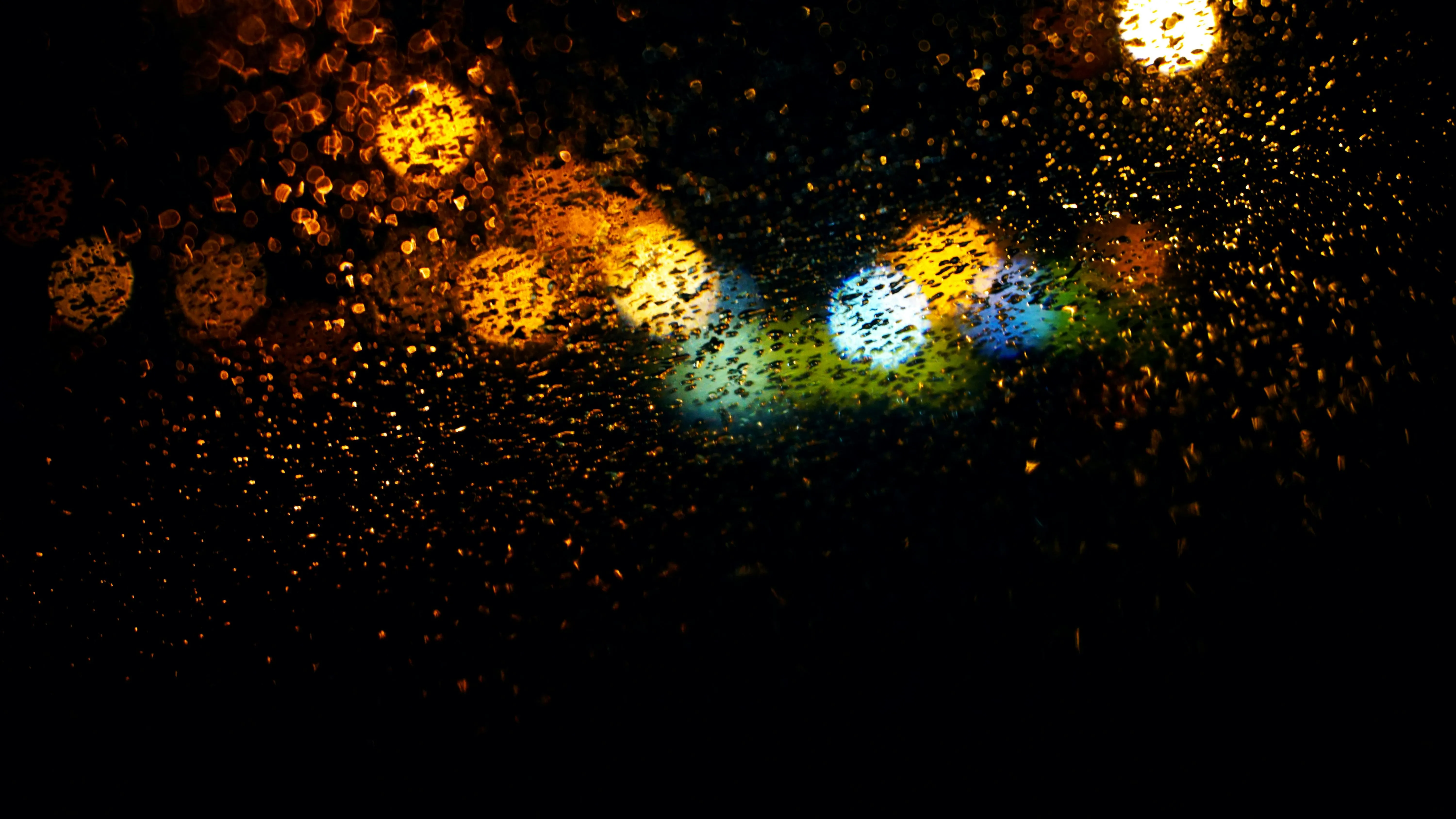 Abstract golden bokeh lights on a dark background Wallpaper