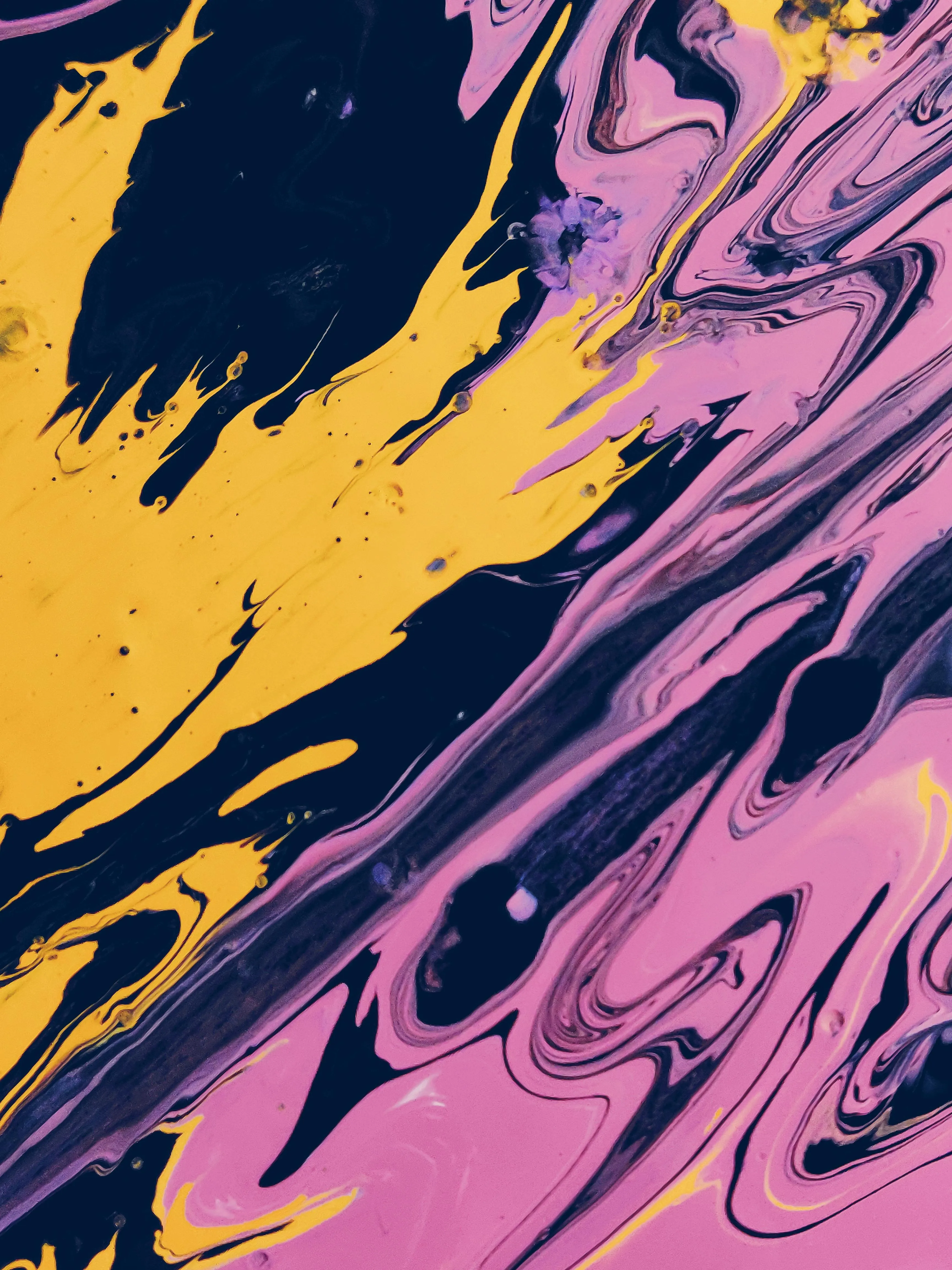 Abstract marbled paint texture with pink yellow and blue