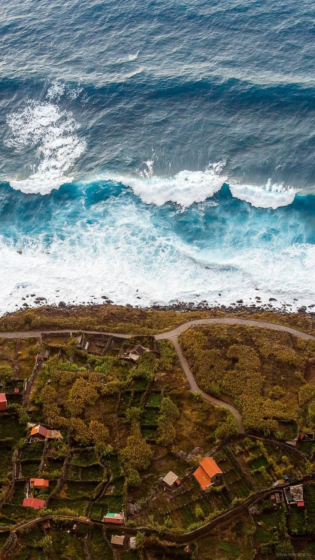 Aerial View of Waves Crashing Against Rocky Coastline