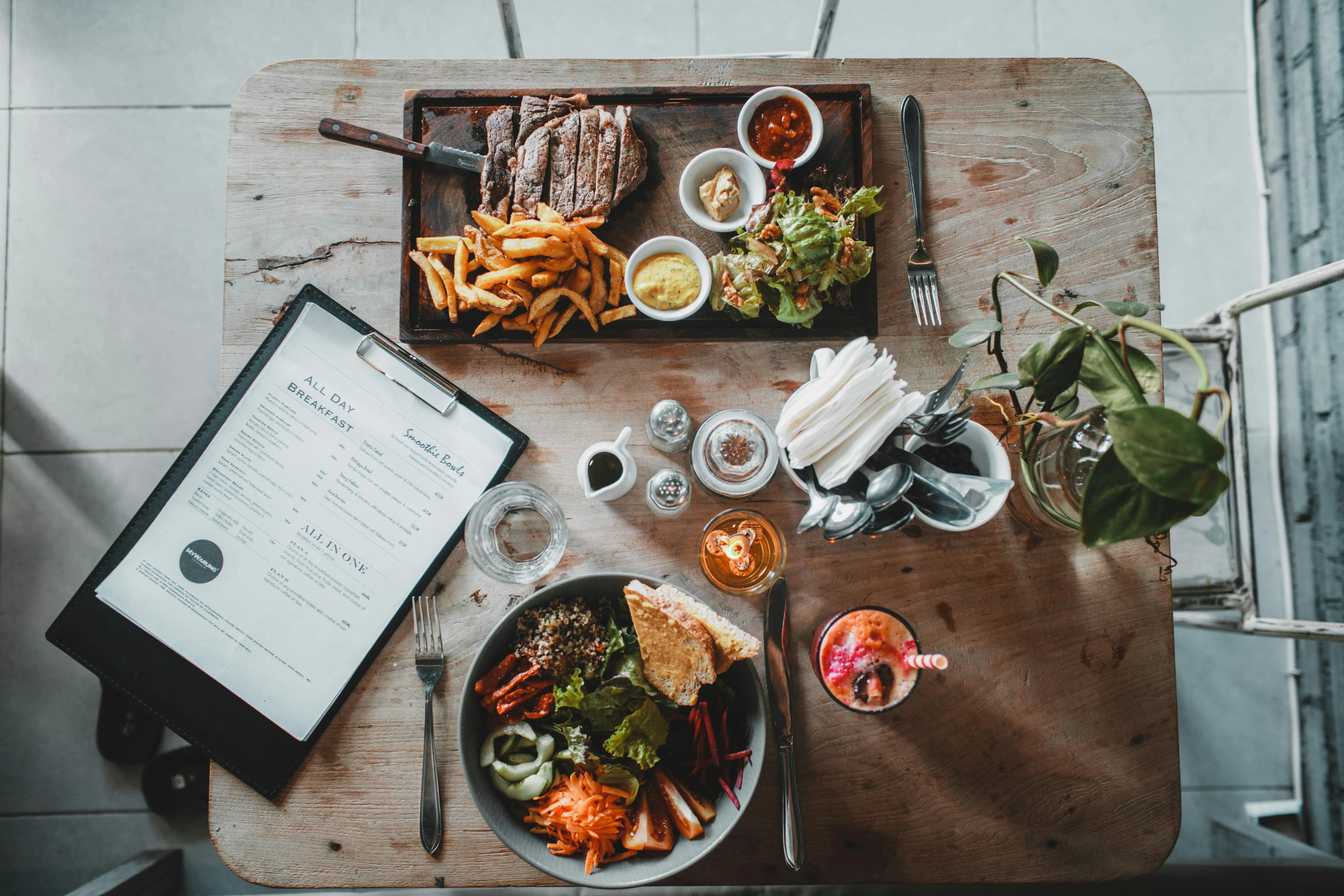 Assorted food dishes with a menu and drinks free Wallpaper