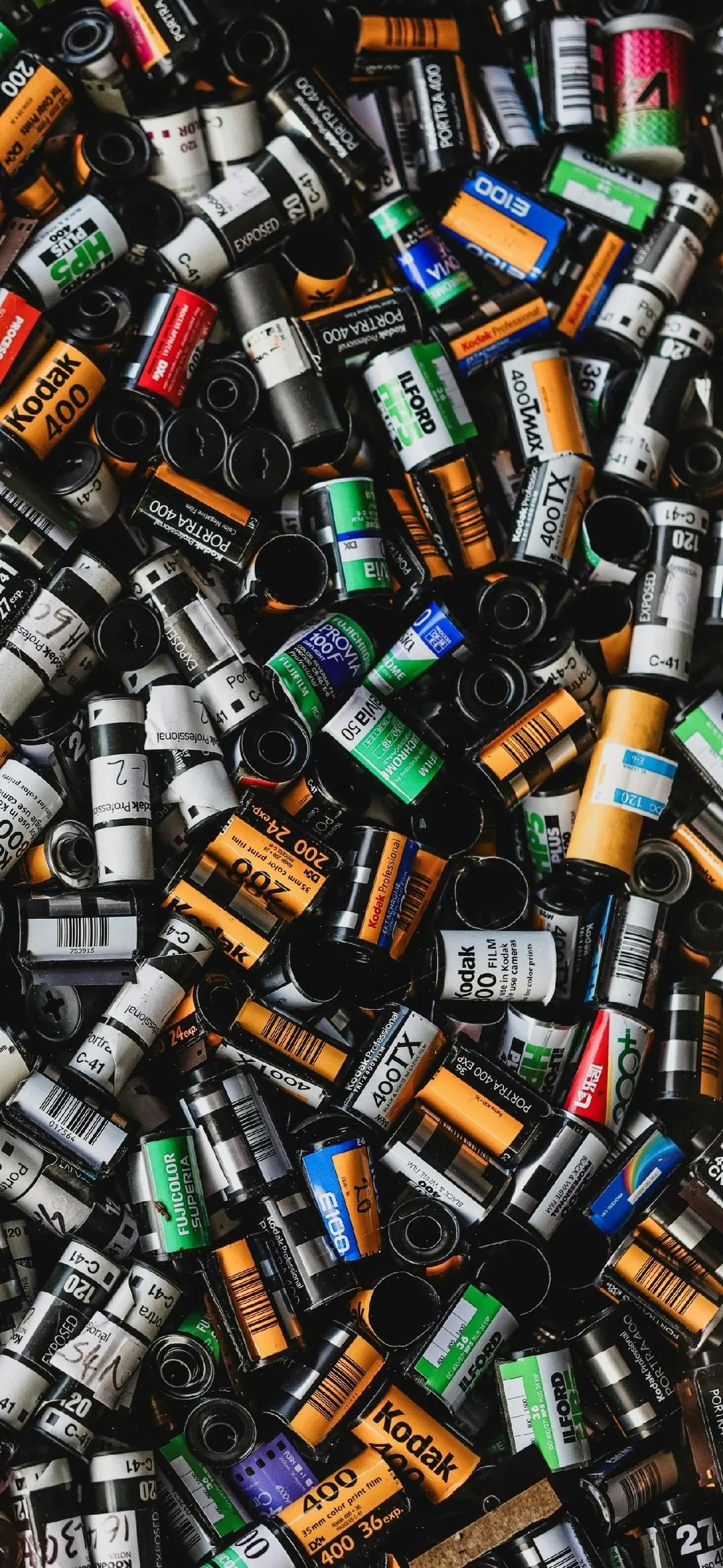 Assorted Photographic Film Rolls Piled Together Wallpaper