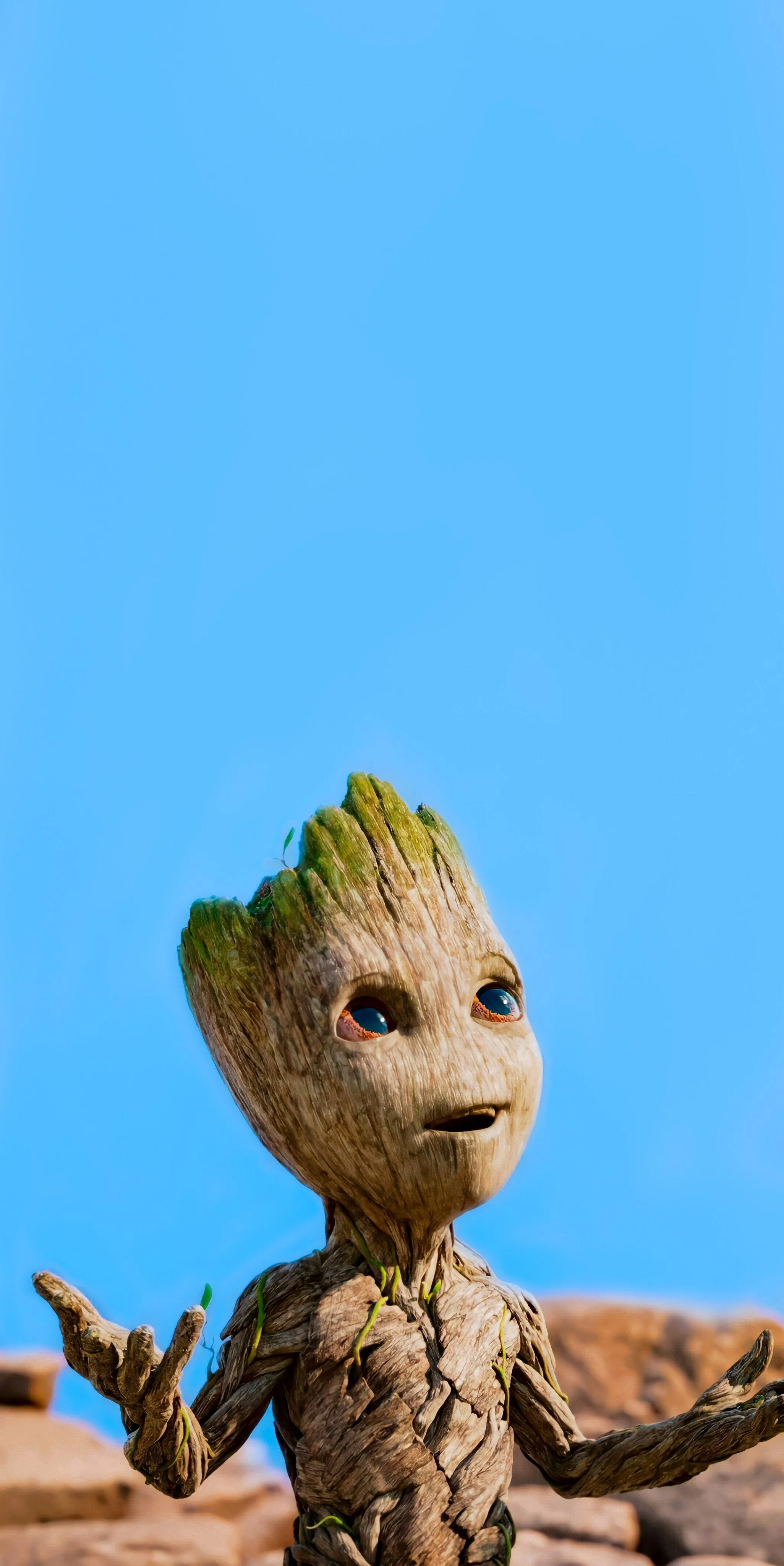 Baby Groot Standing on Ground with Blue Sky Wallpaper