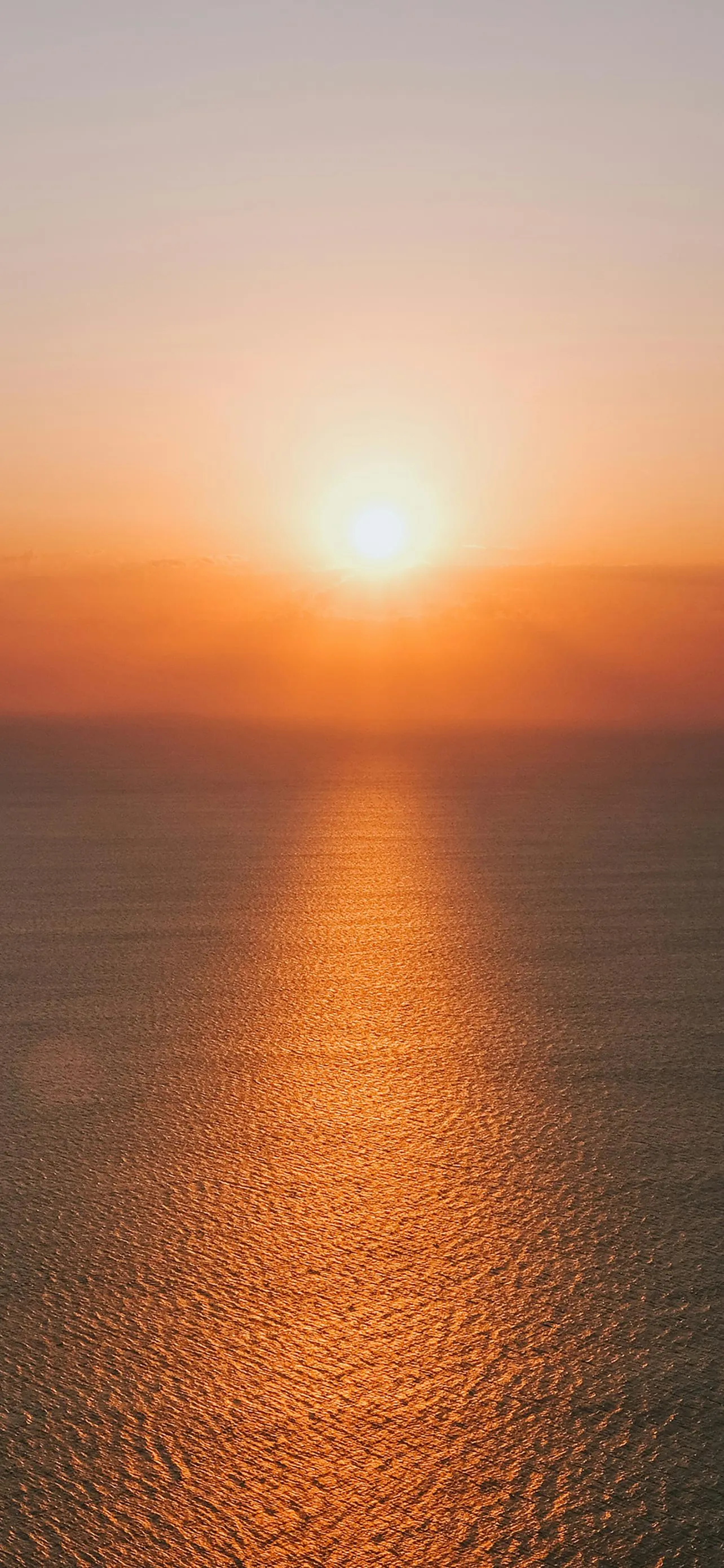 Beautiful Sunset Over Calm Ocean with Warm Orange Colors