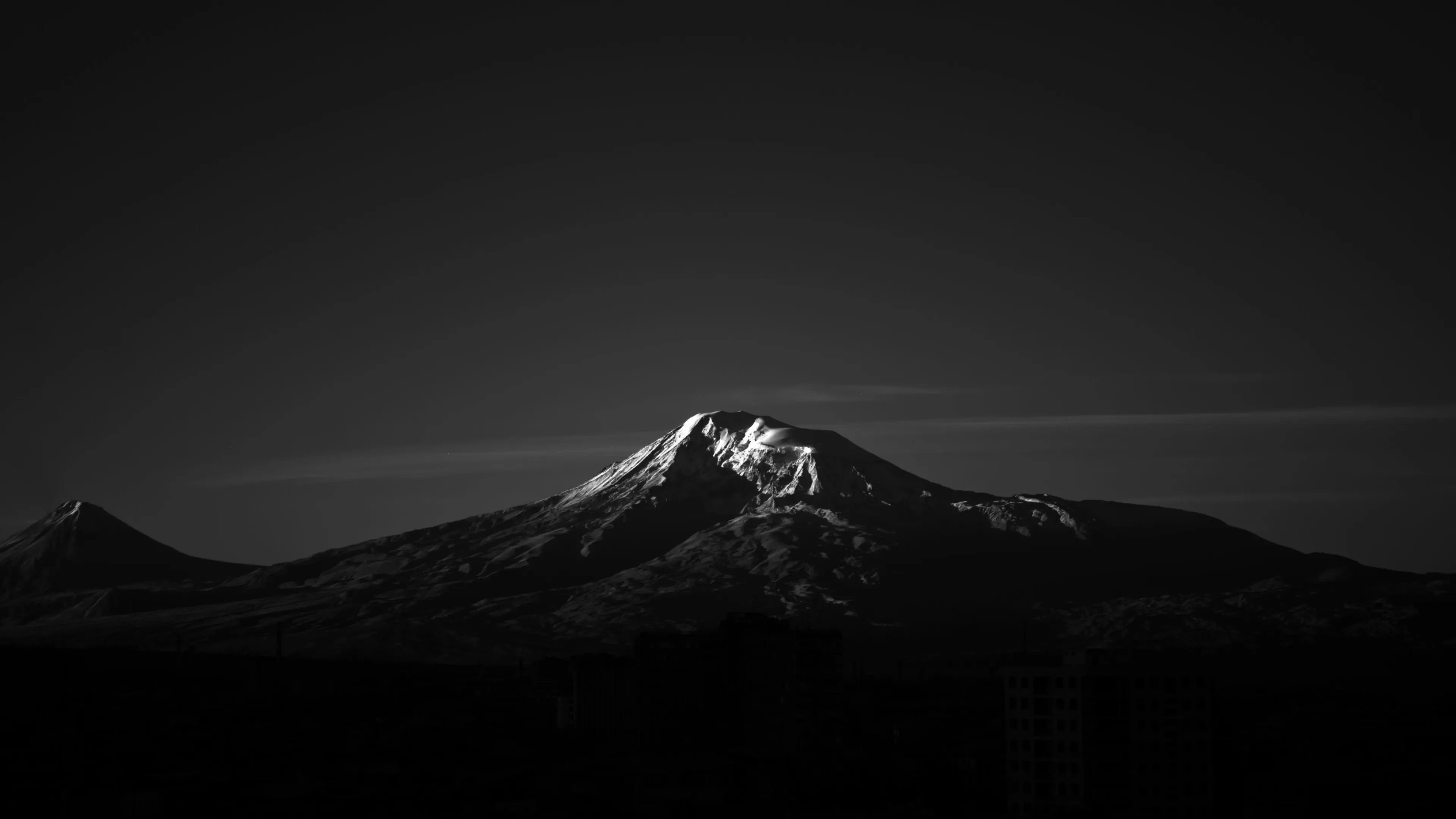 Black and white mountain landscape with dramatic shadows