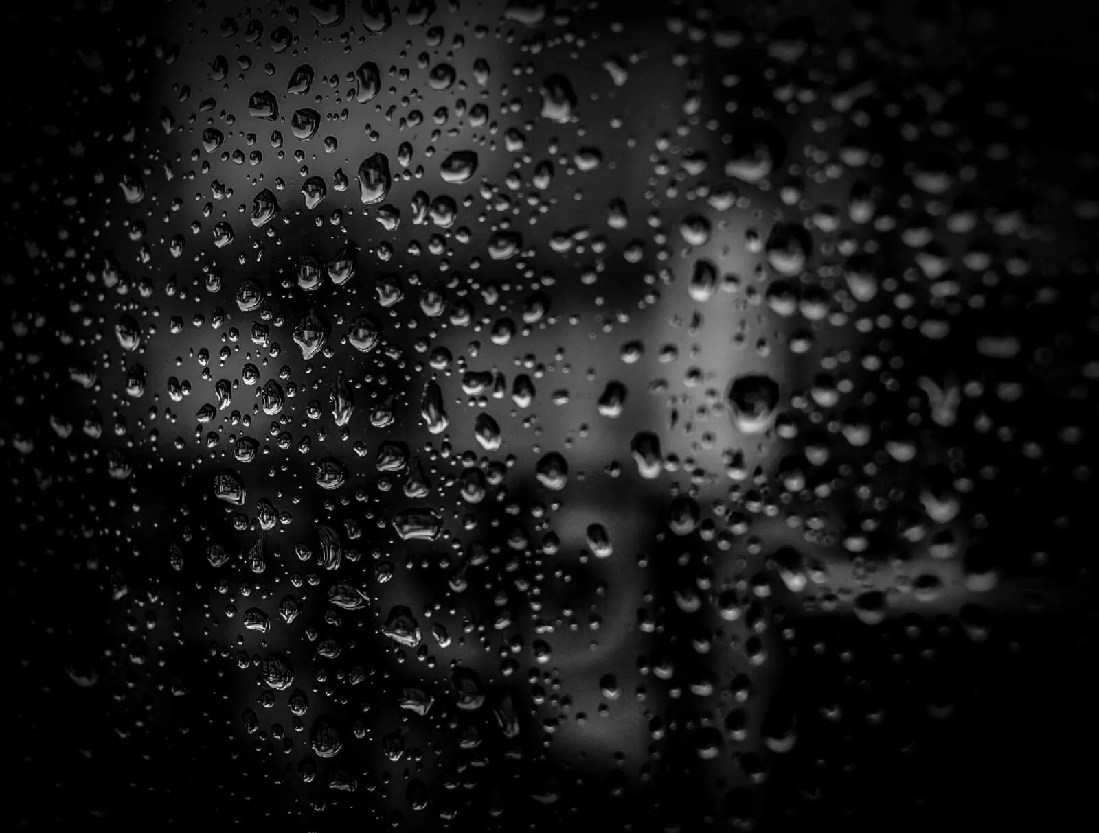 Black and white water droplets on a glass surface Wallpaper