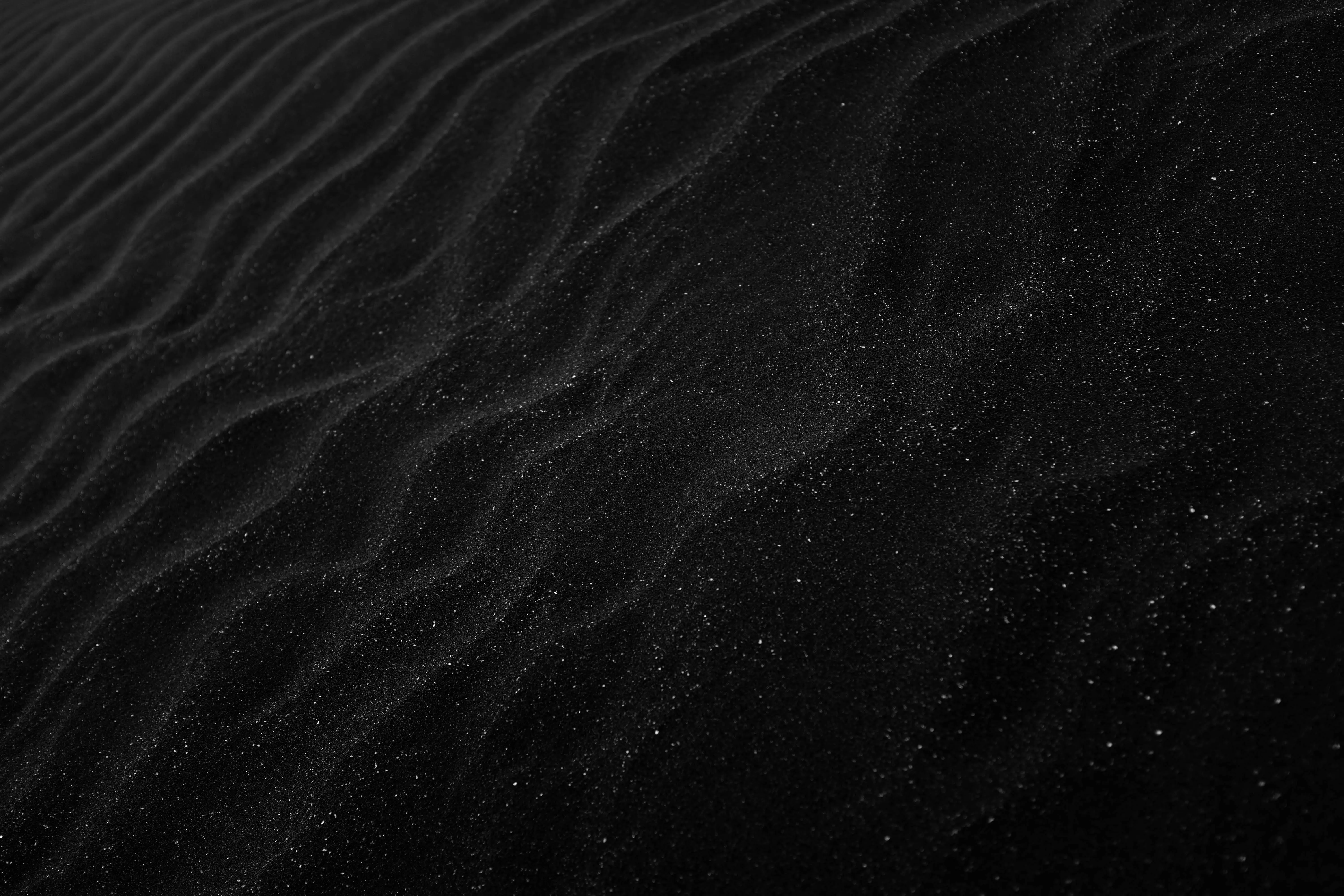 Black desert sand texture with fine soft wave patterns image