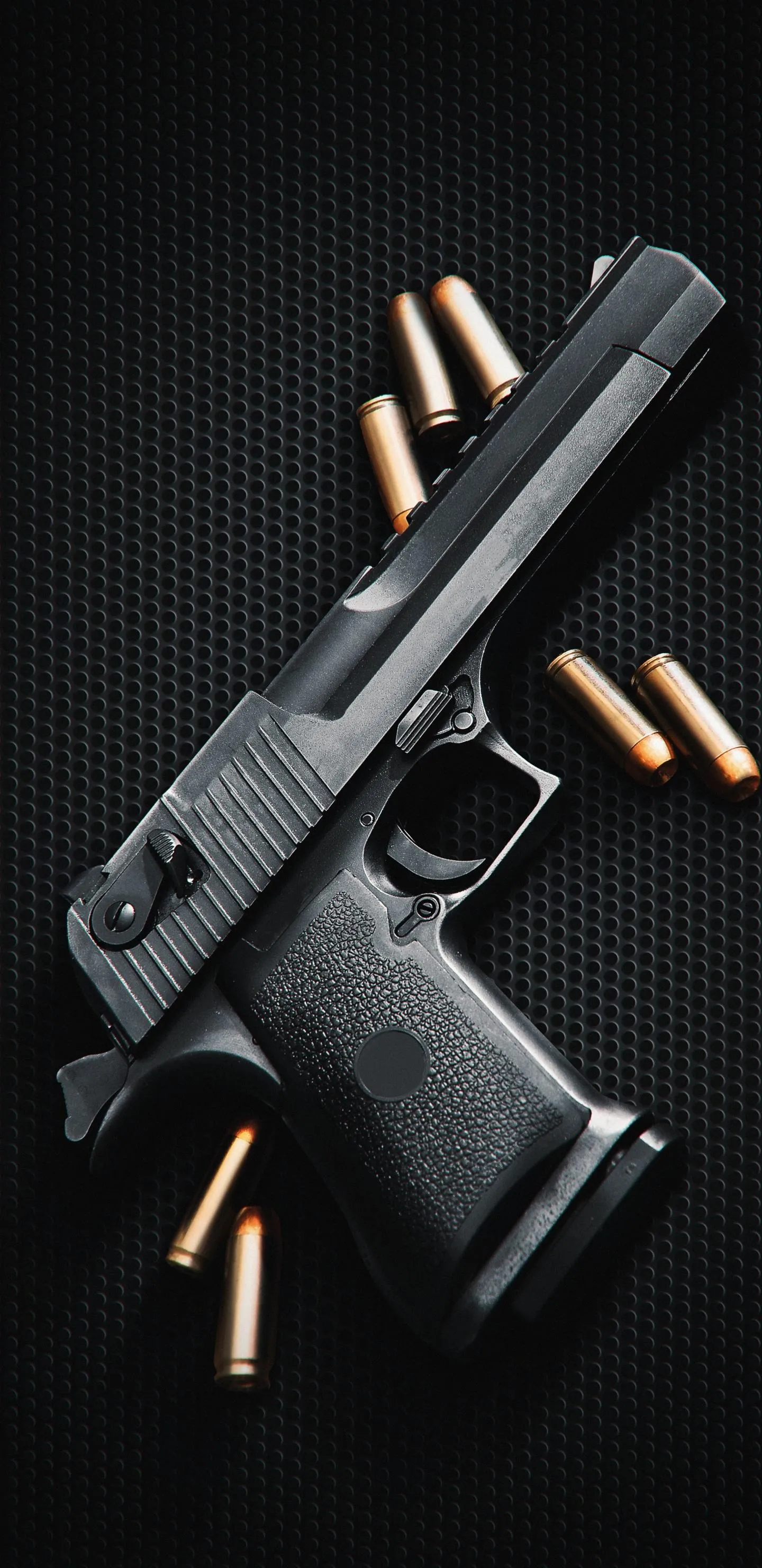 Black Handgun with Bullets on Matte Background Wallpaper