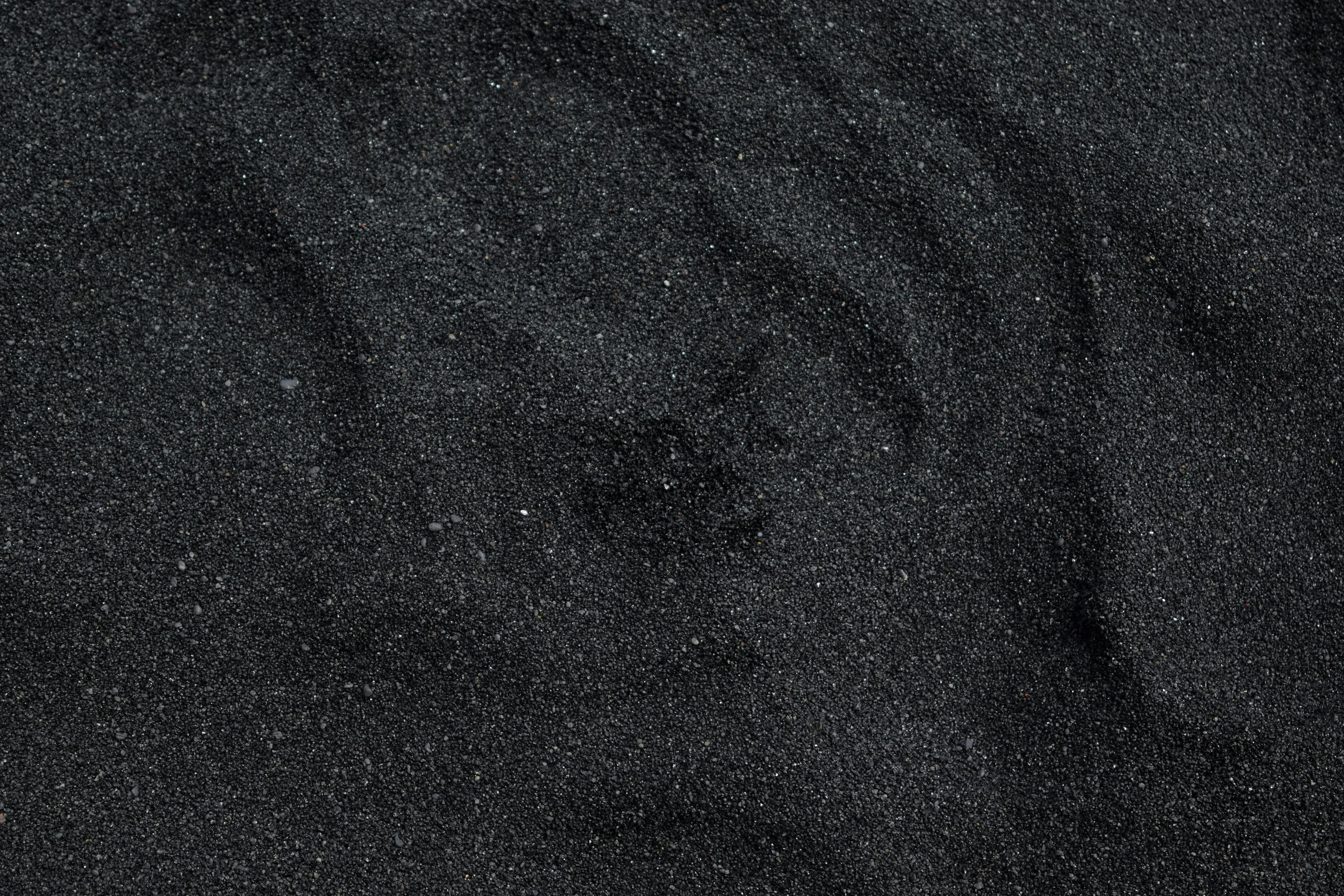 Black sand texture with natural shadows and details image