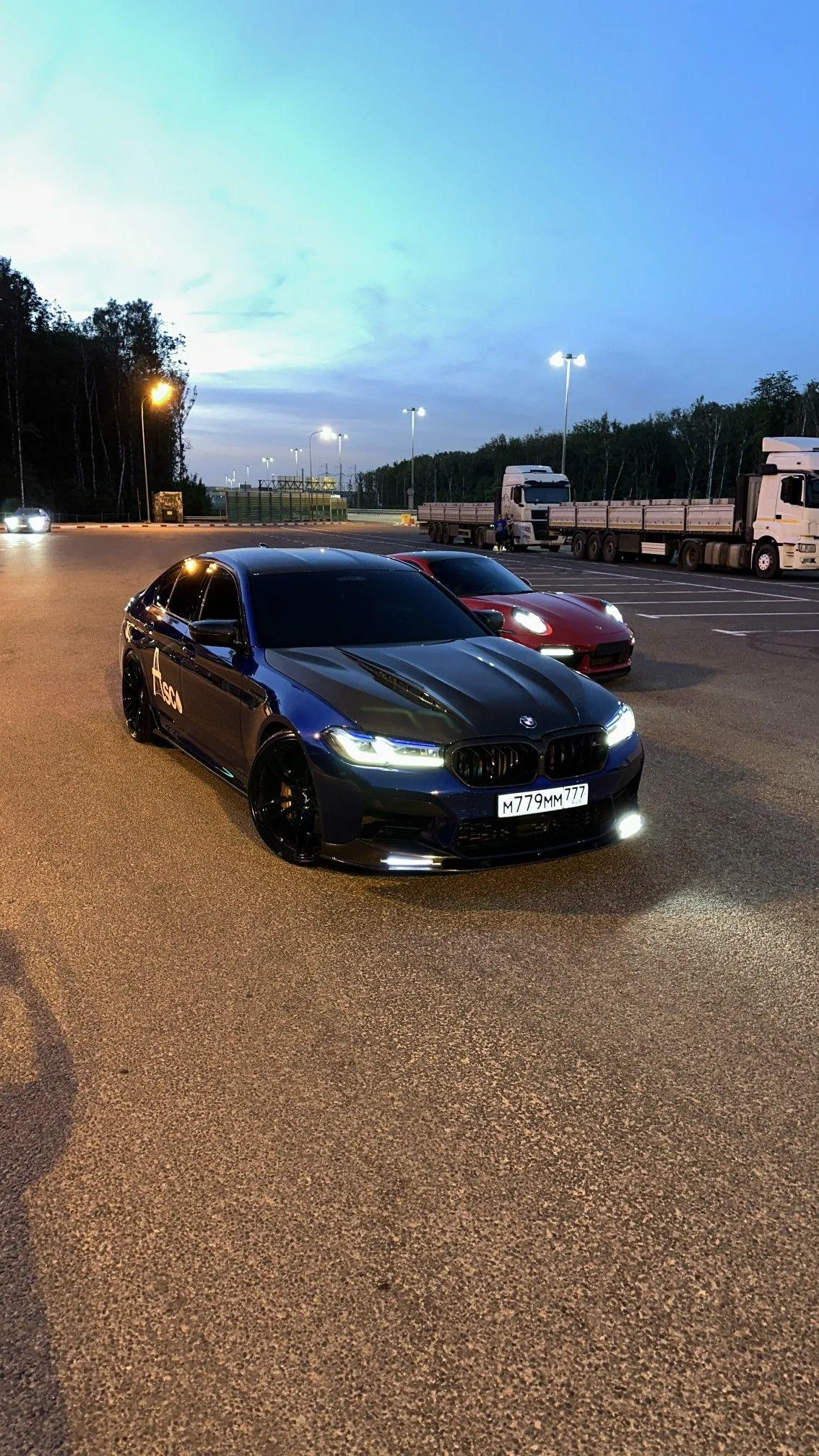 Black sports car driving on road at sunset Wallpaper