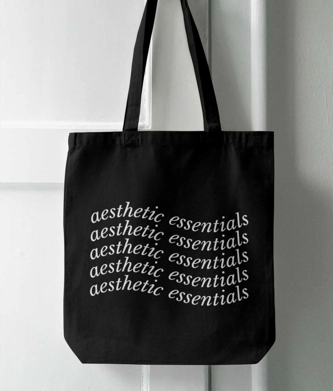 Black tote bag with repeated white aesthetic essentials 4K