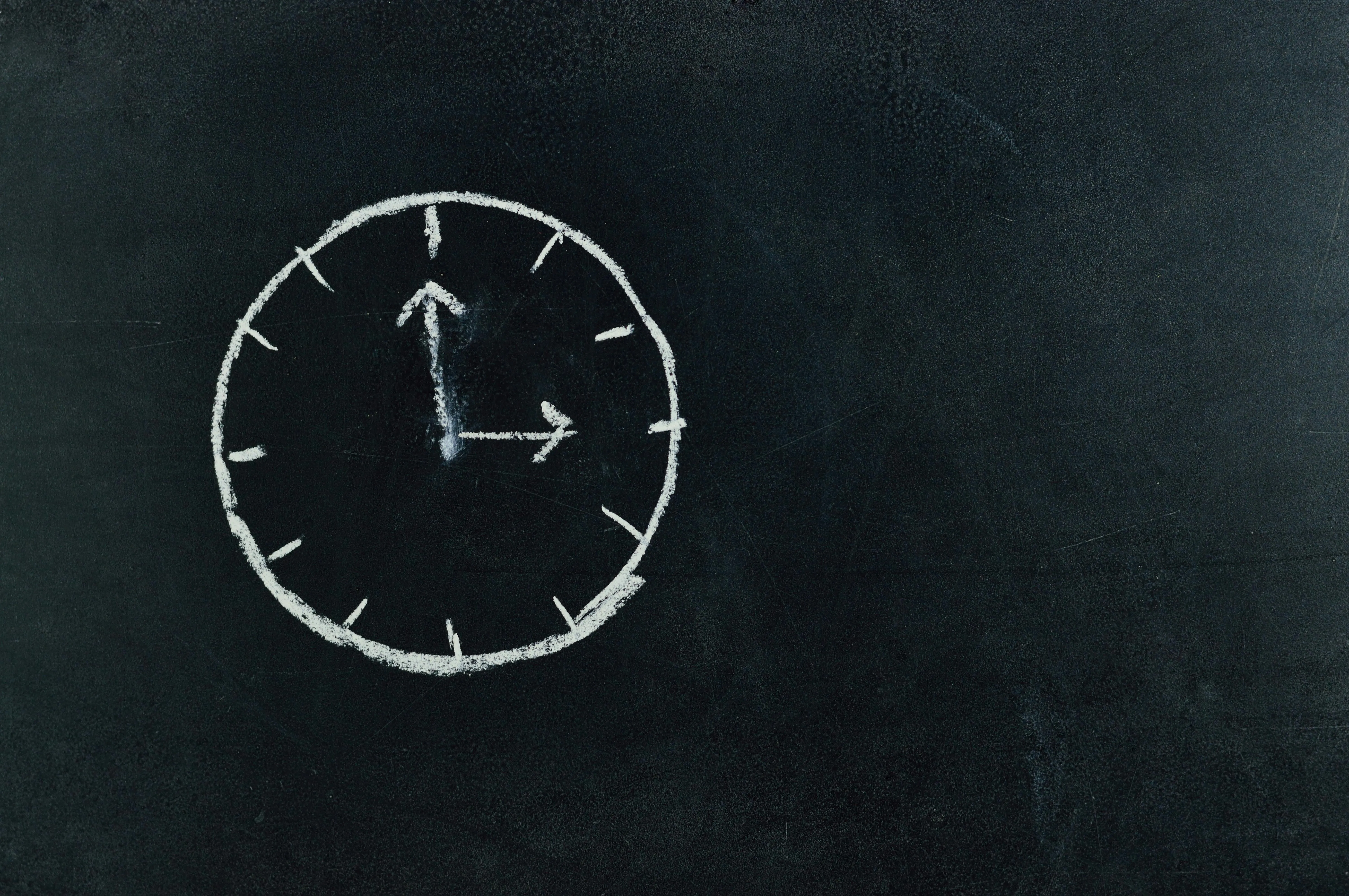Blackboard drawing of a clock showing three O clock image