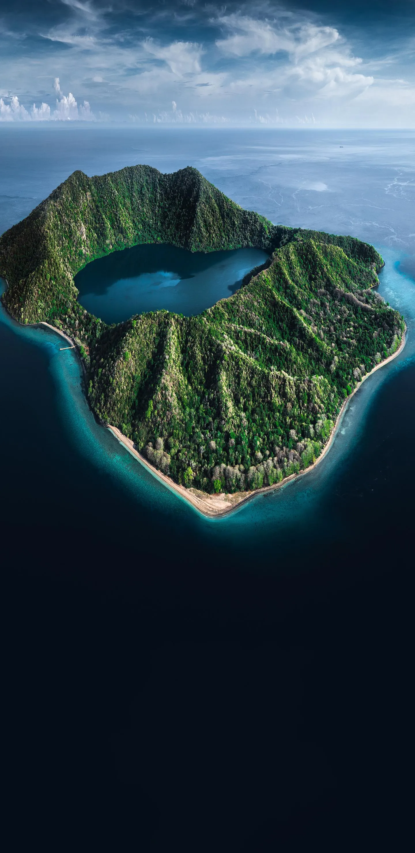Blue Lagoon Island Surrounded by Deep Ocean Aerial View