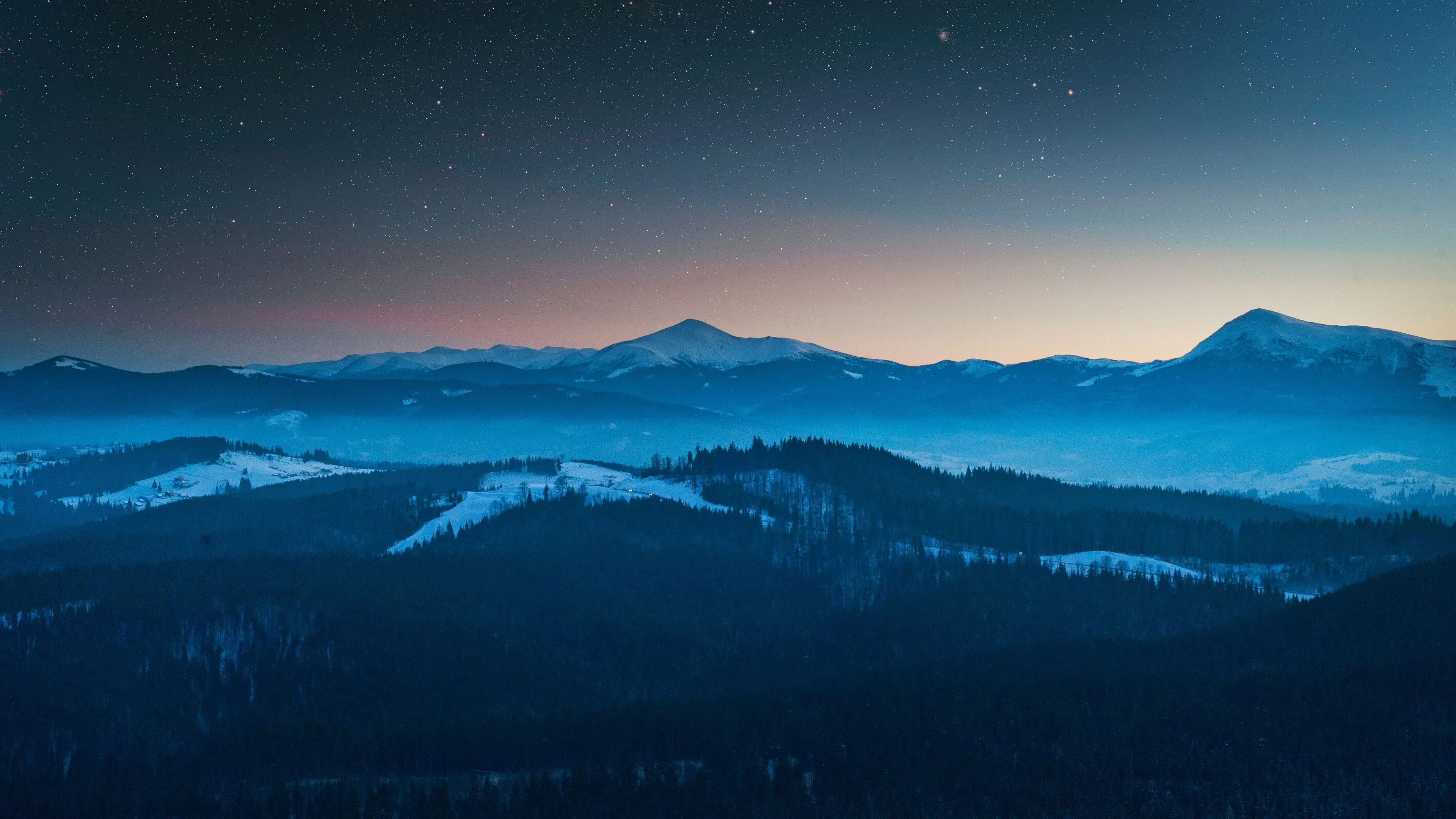 Blue mountain range at dusk with clear sky and stars image