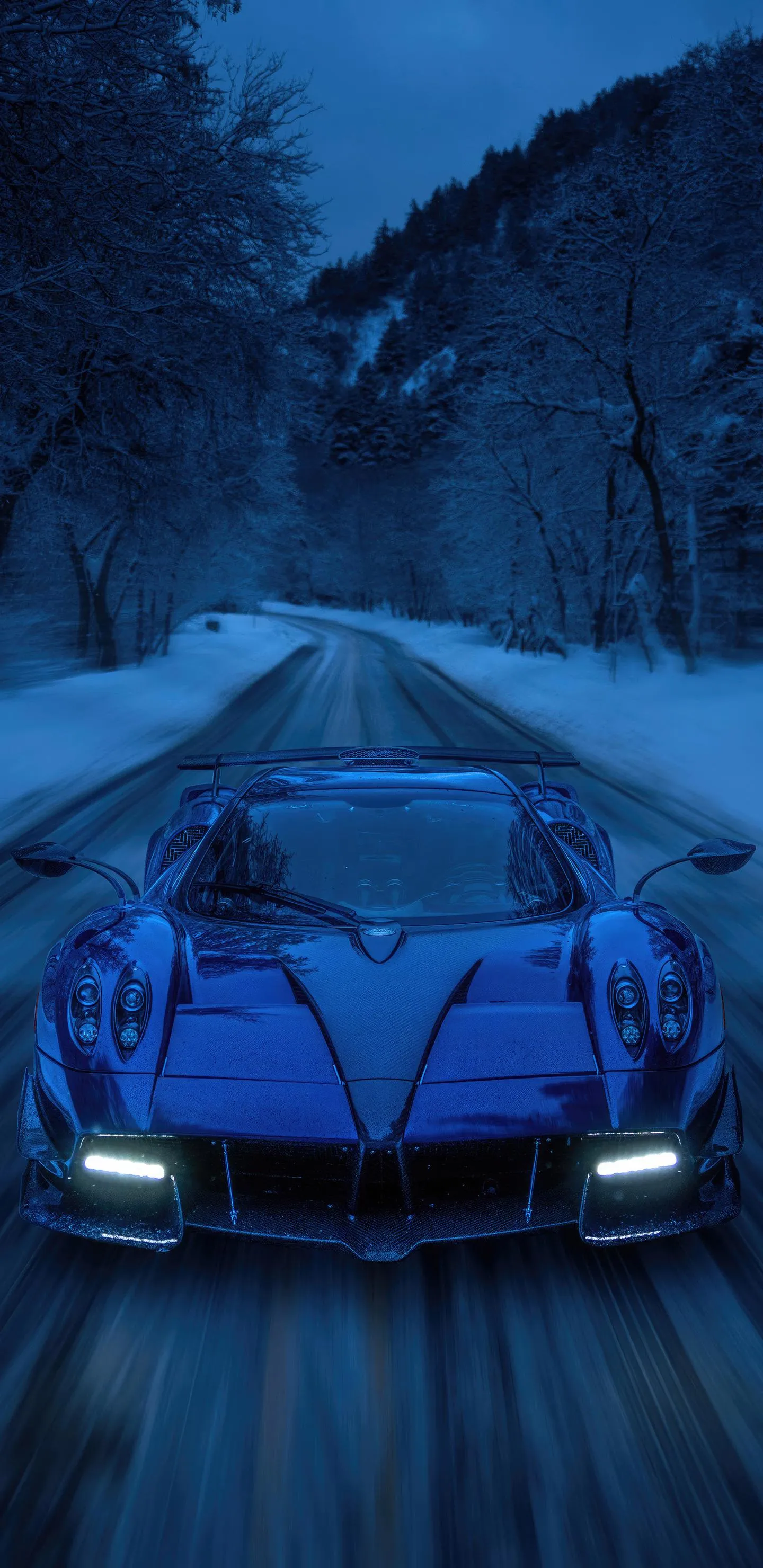 Blue Sports Car Driving Through a Snowy Mountain Pass