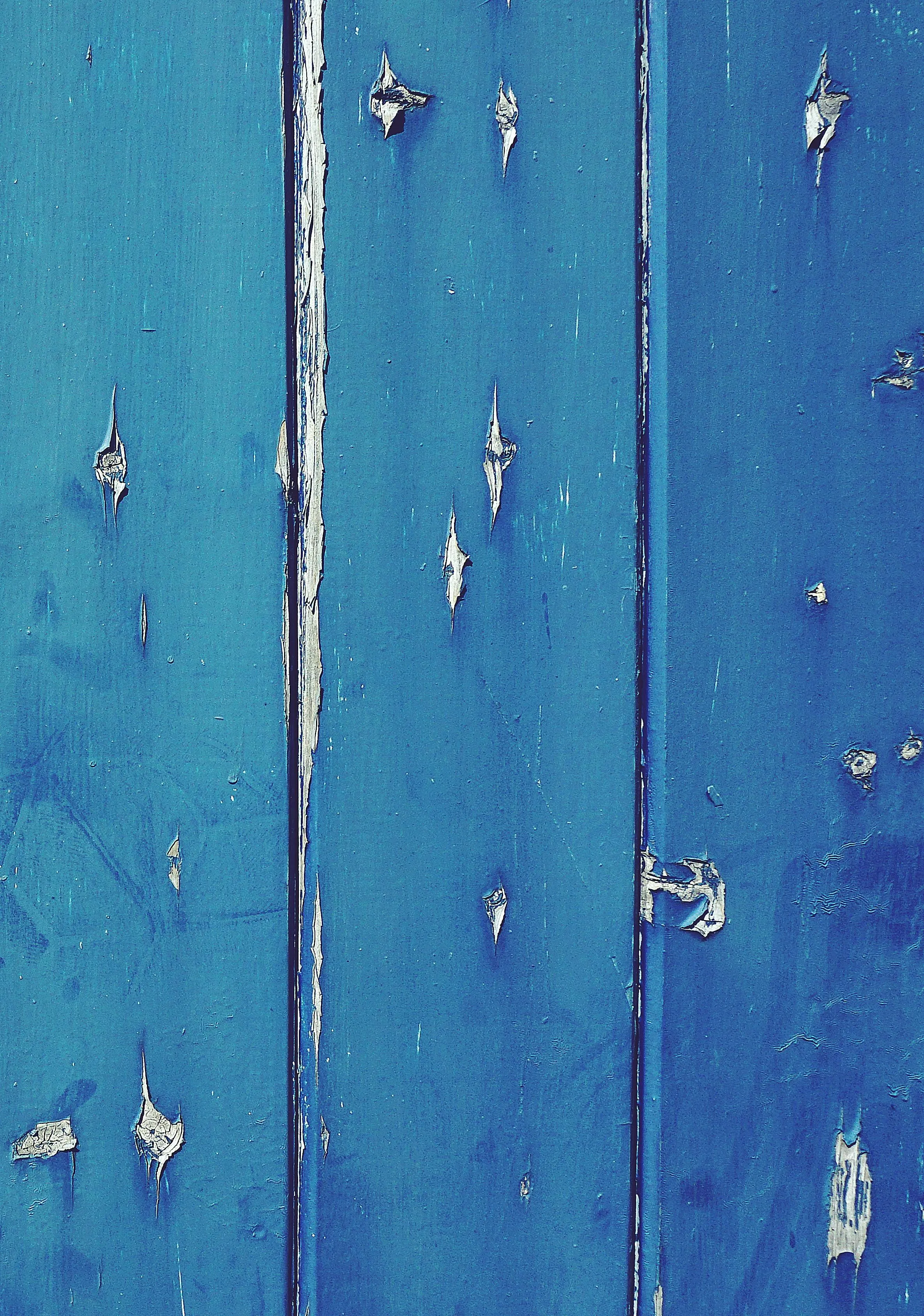 Blue wooden boards with peeling paint and cracks Wallpaper