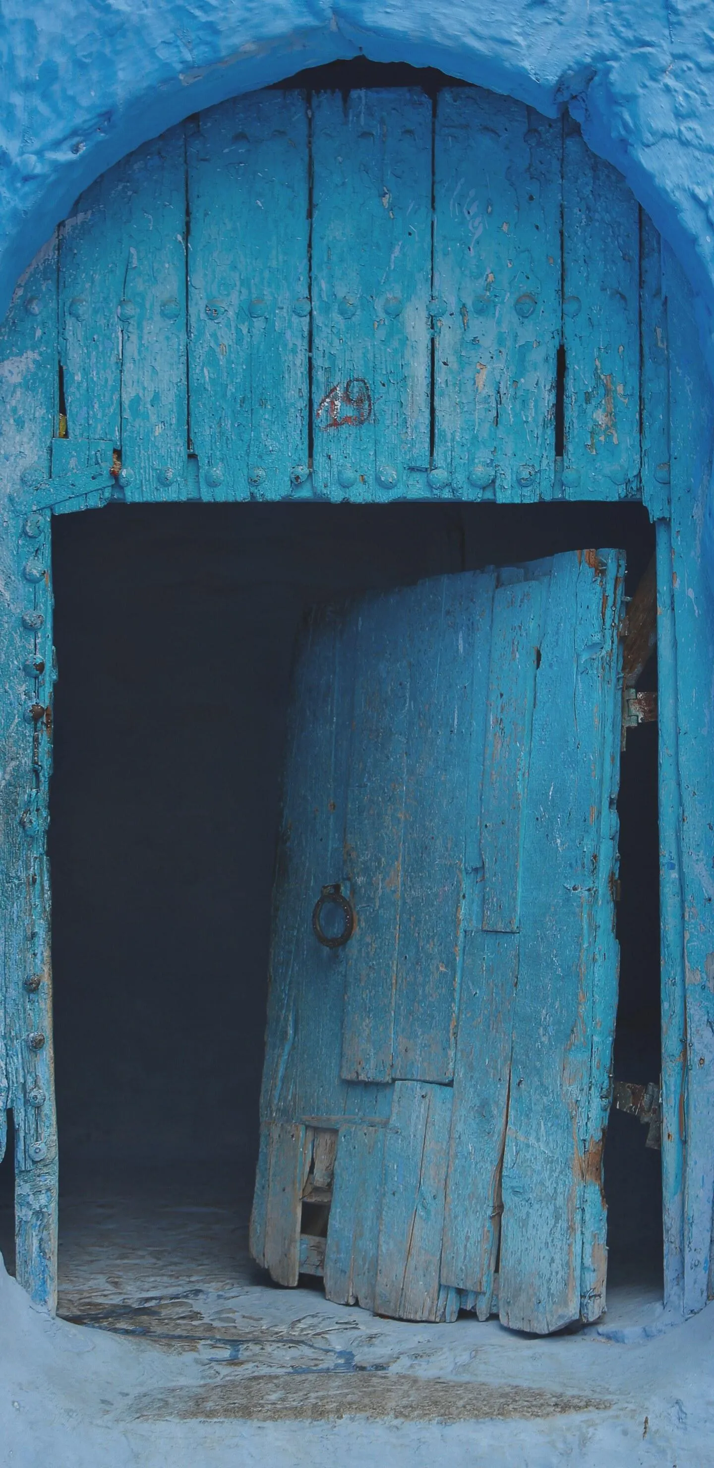 Blue Wooden Door on Vintage House with Rustic Texture