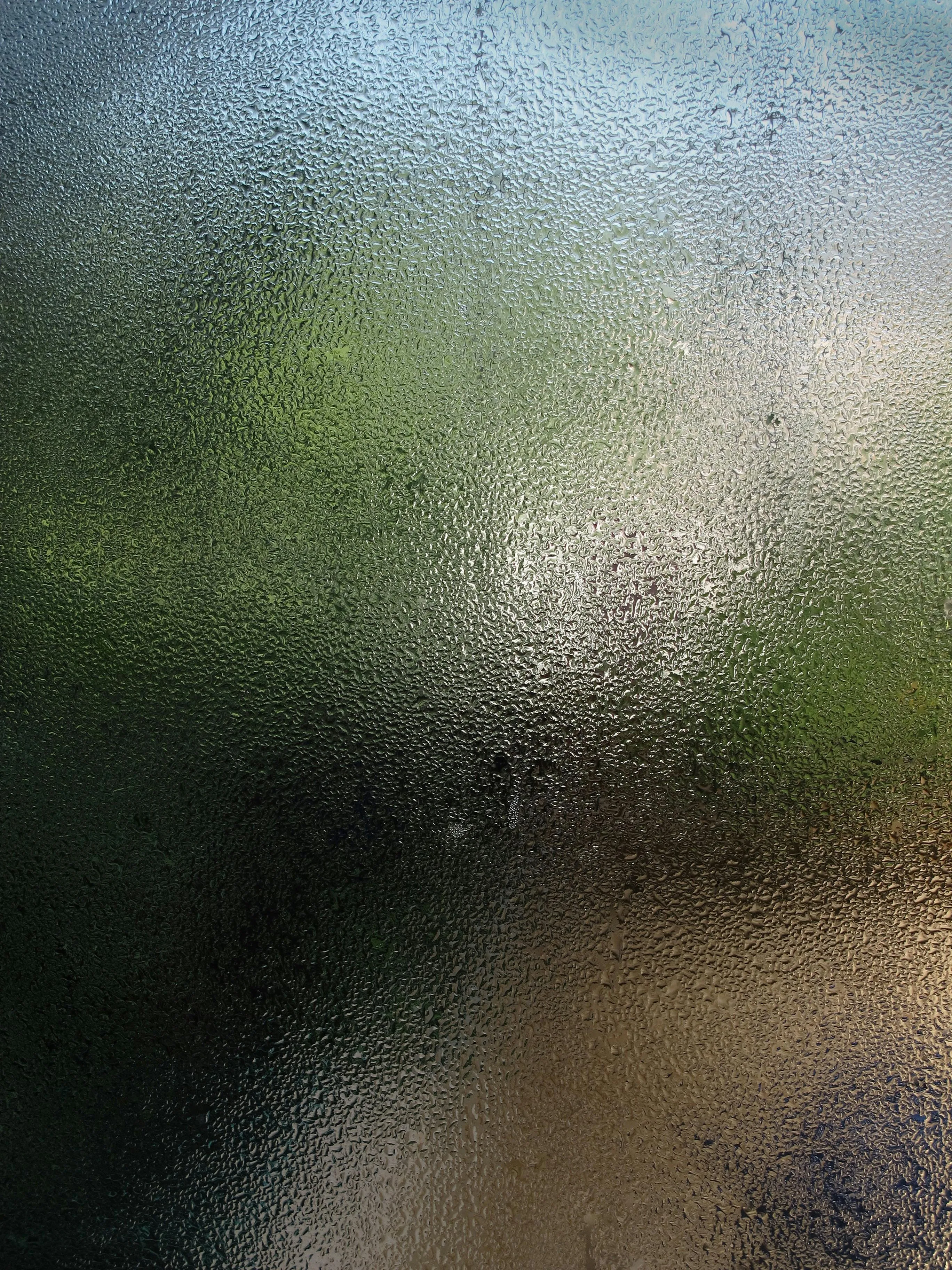 Blurred rainy glass window with a natural view outside HD