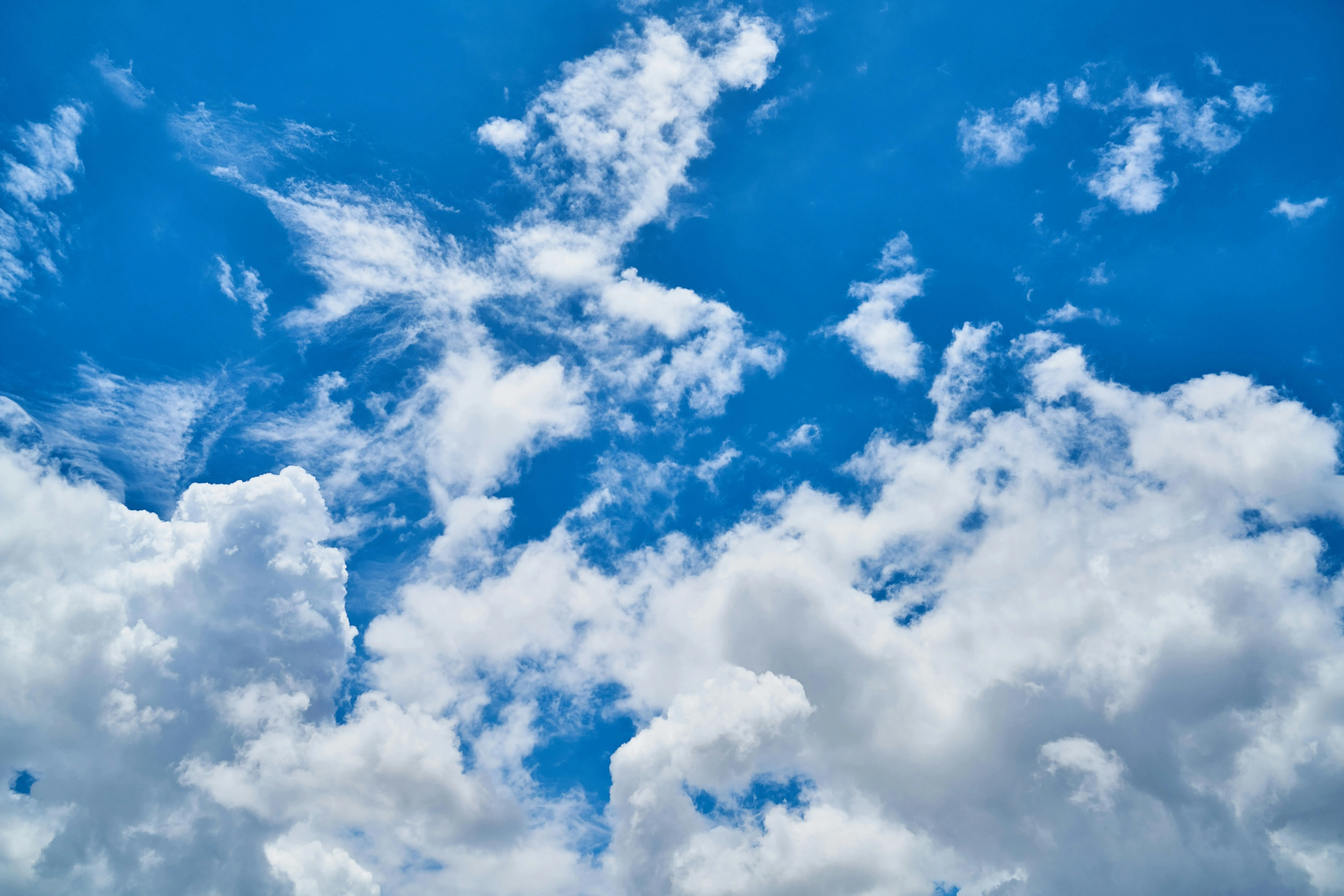 Bright blue sky with white fluffy clouds on a sunny day