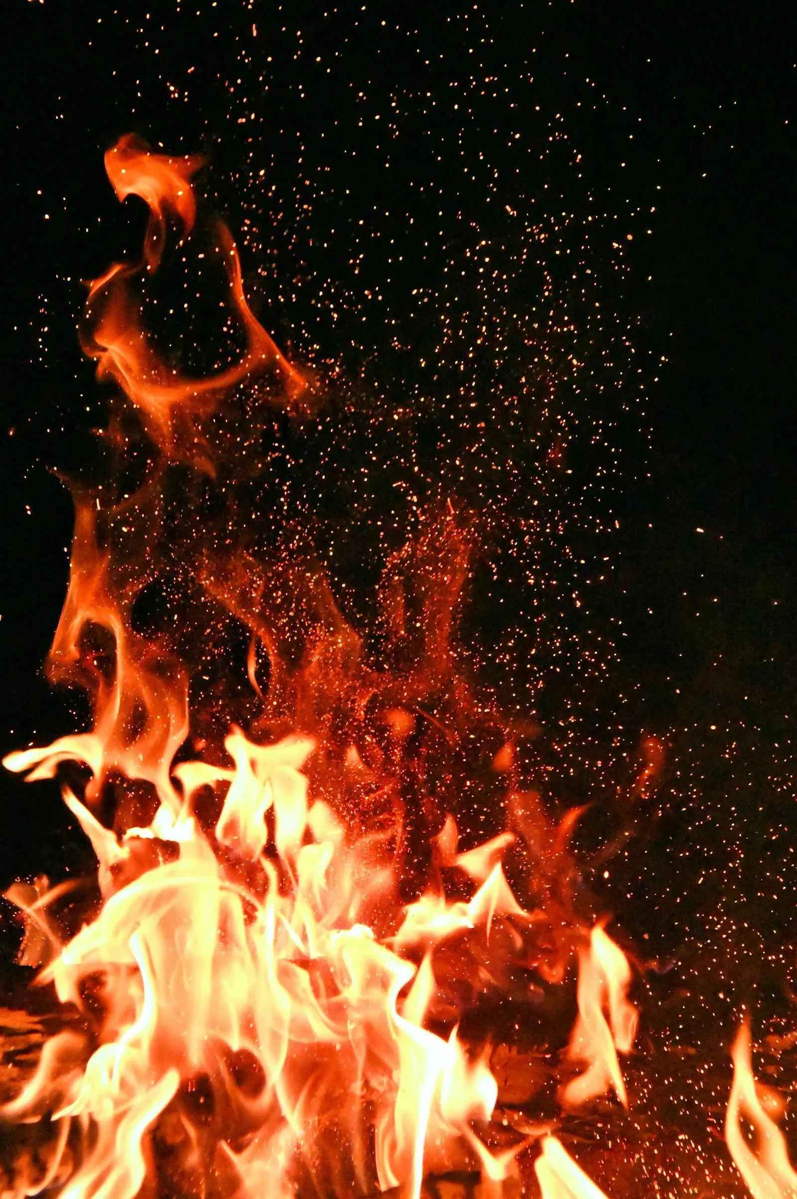 Bright flames flickering against a dark black background