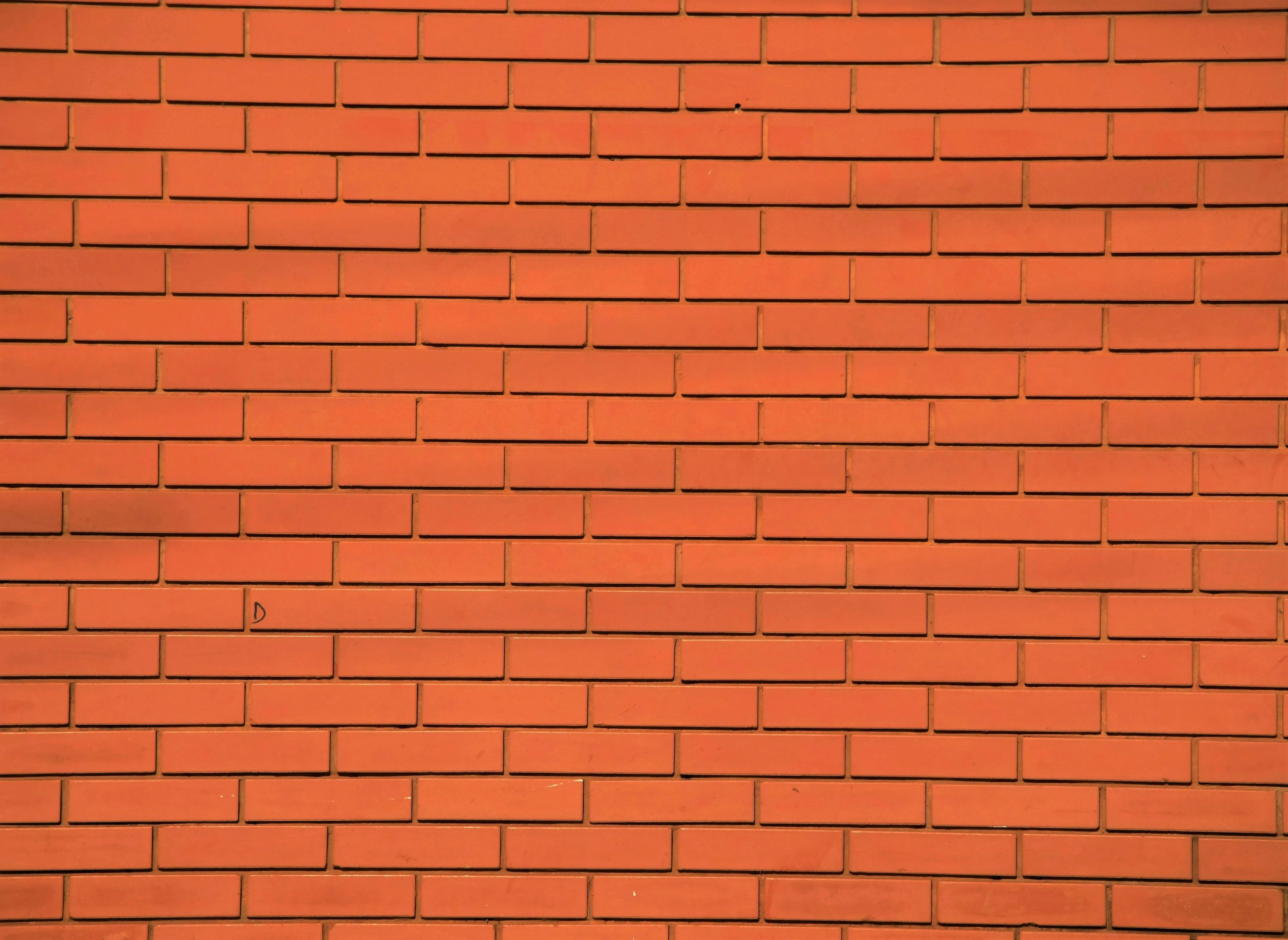 Bright red brick wall background with clean solid lines