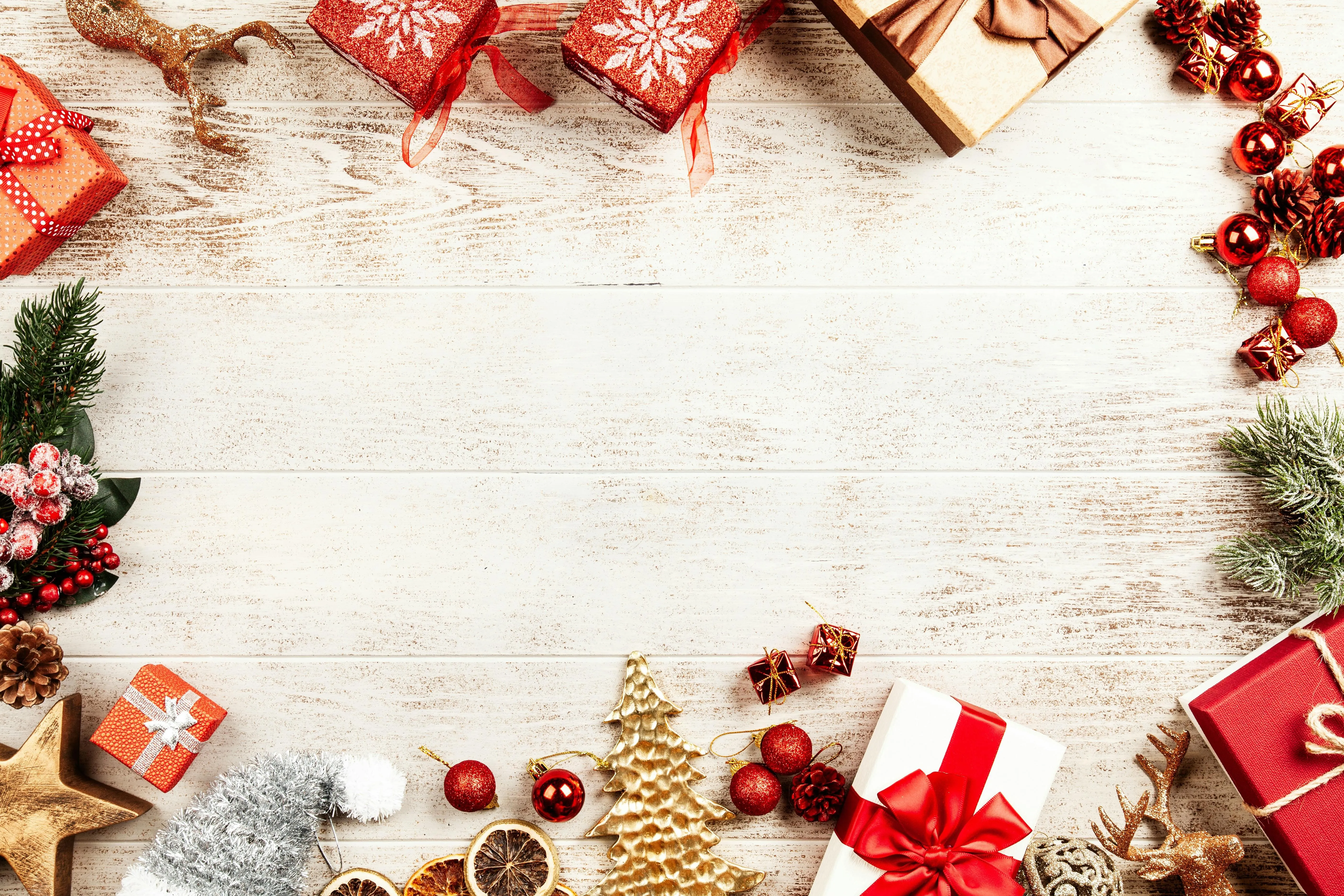 Christmas decorations with gifts on a wooden table Wallpaper
