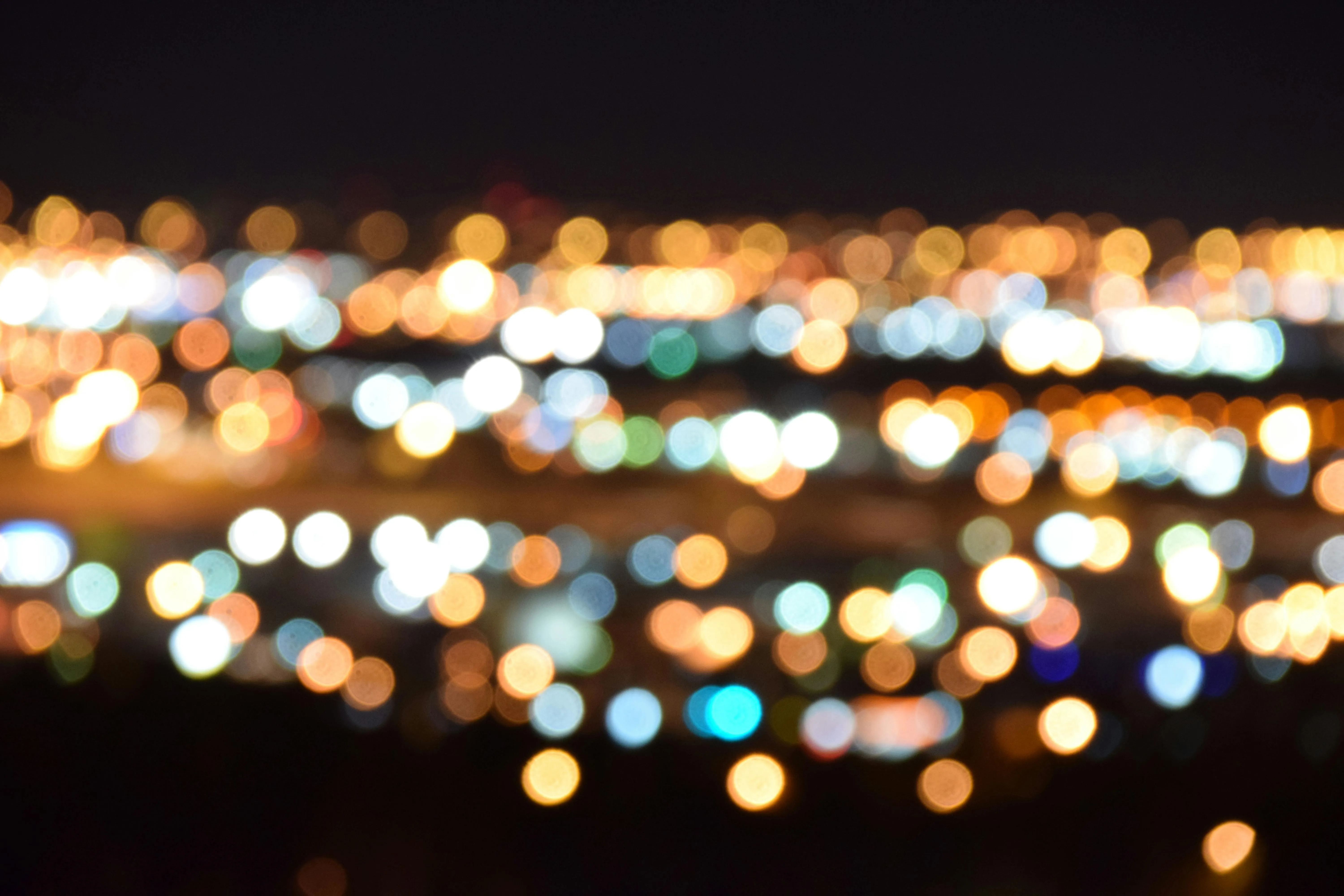 City lights blurred at night with a colourful bokeh effect