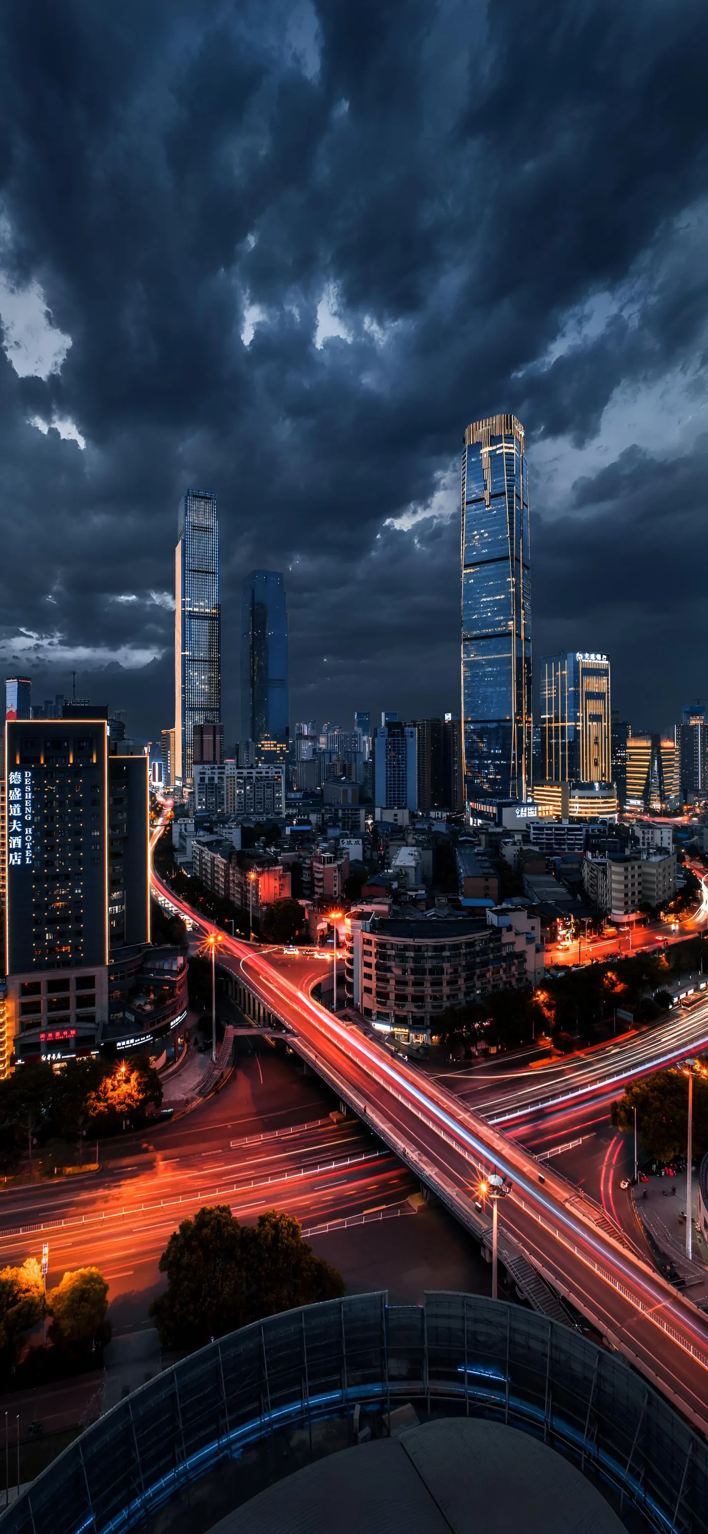 Cityscape at night with dramatic dark stormy clouds