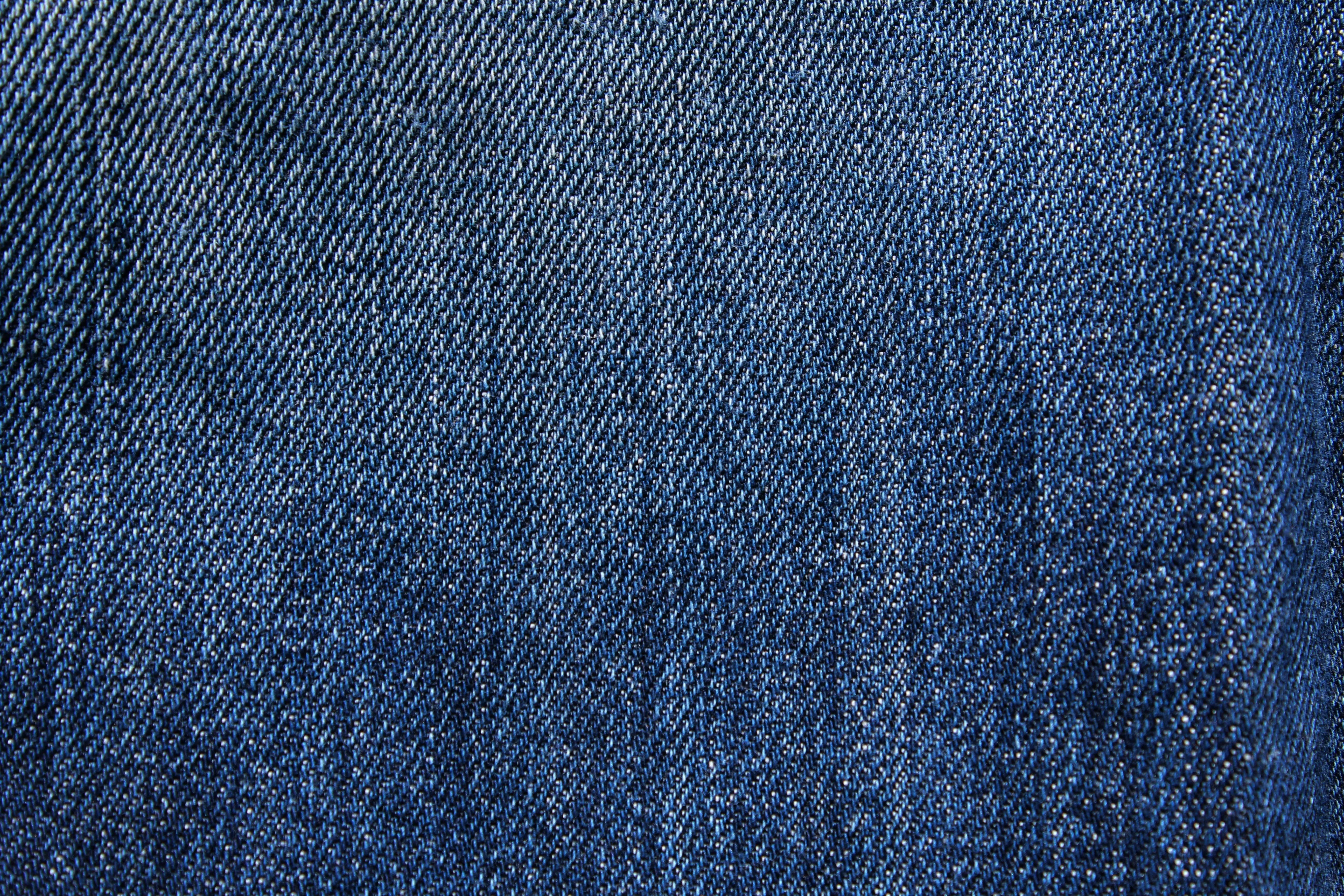 Classic blue denim fabric texture in close detail Wallpaper