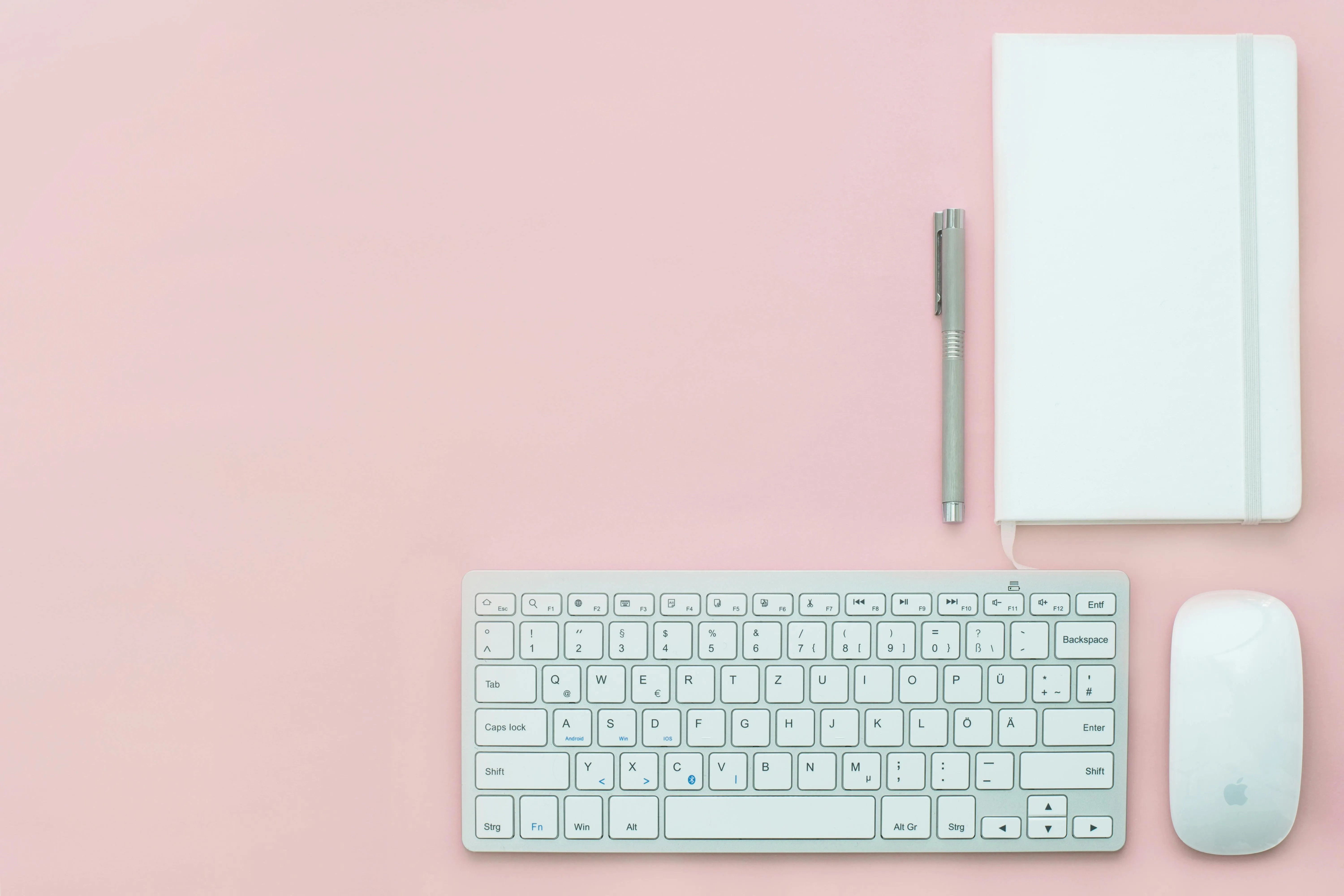 Clean desktop workspace with keyboard mouse and notebook