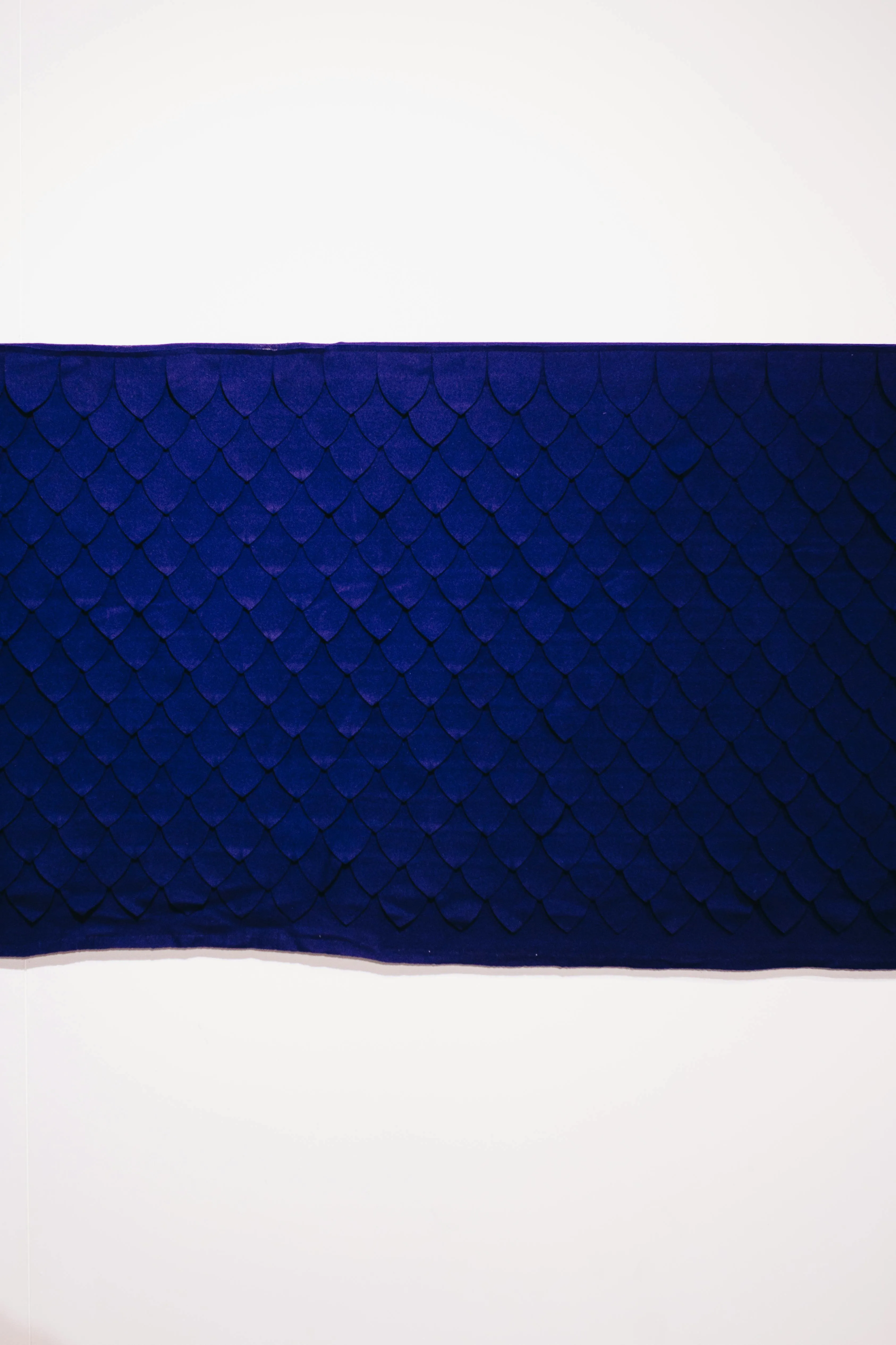 Close up of a blue textured fabric on a white background