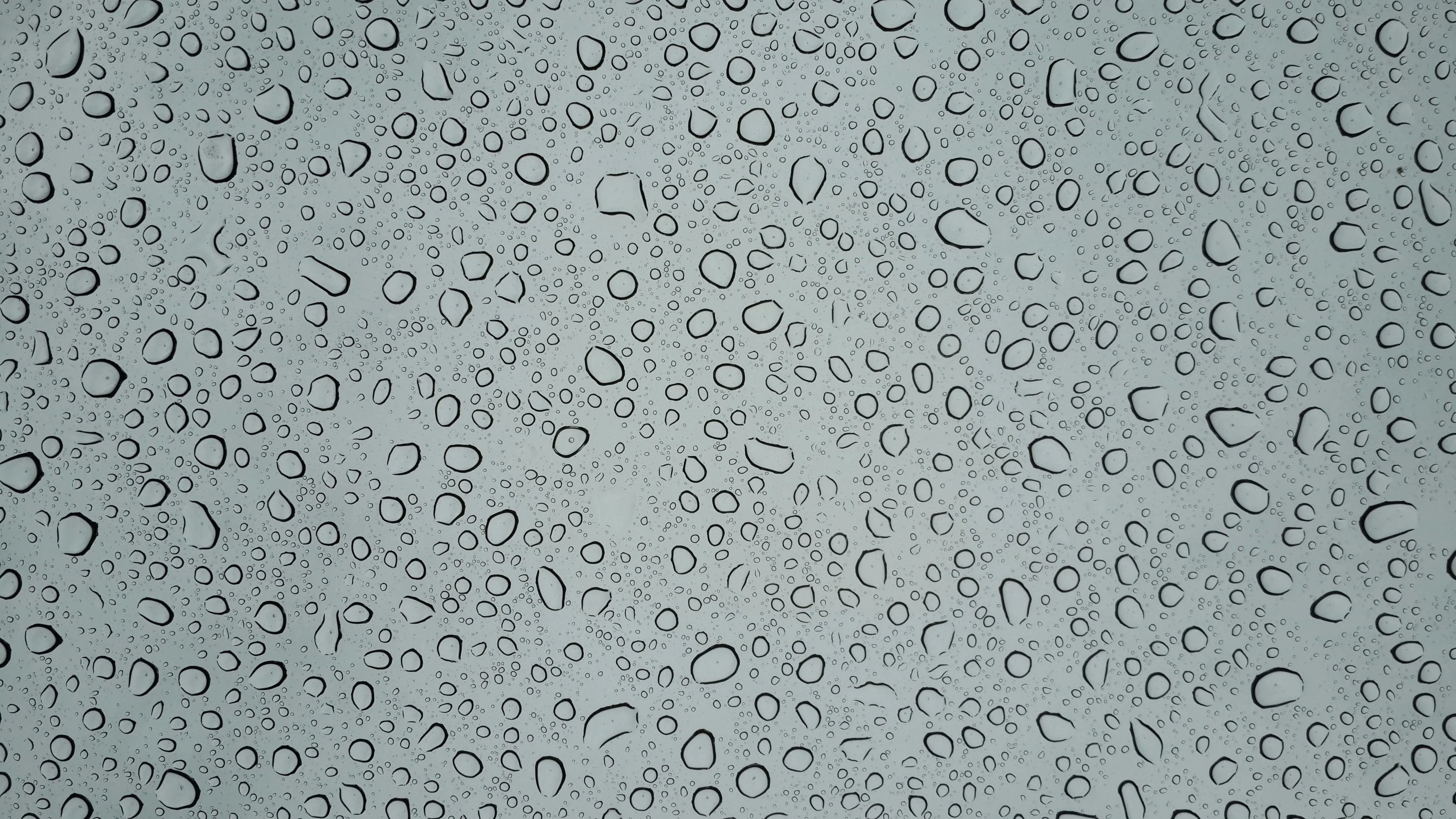 Close up of water droplets on a smooth glass surface 4K