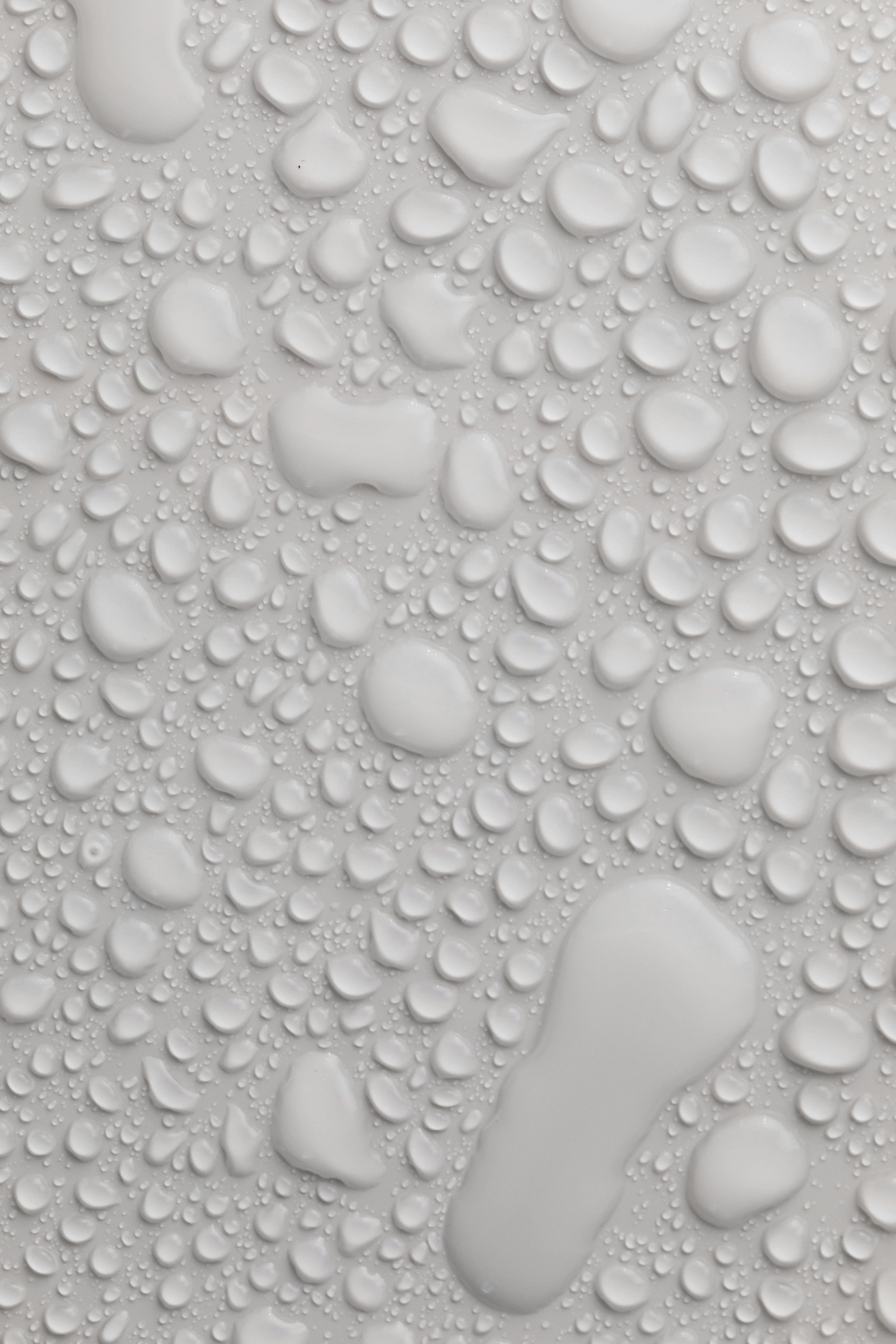 Close up of water droplets on a smooth gray surface image