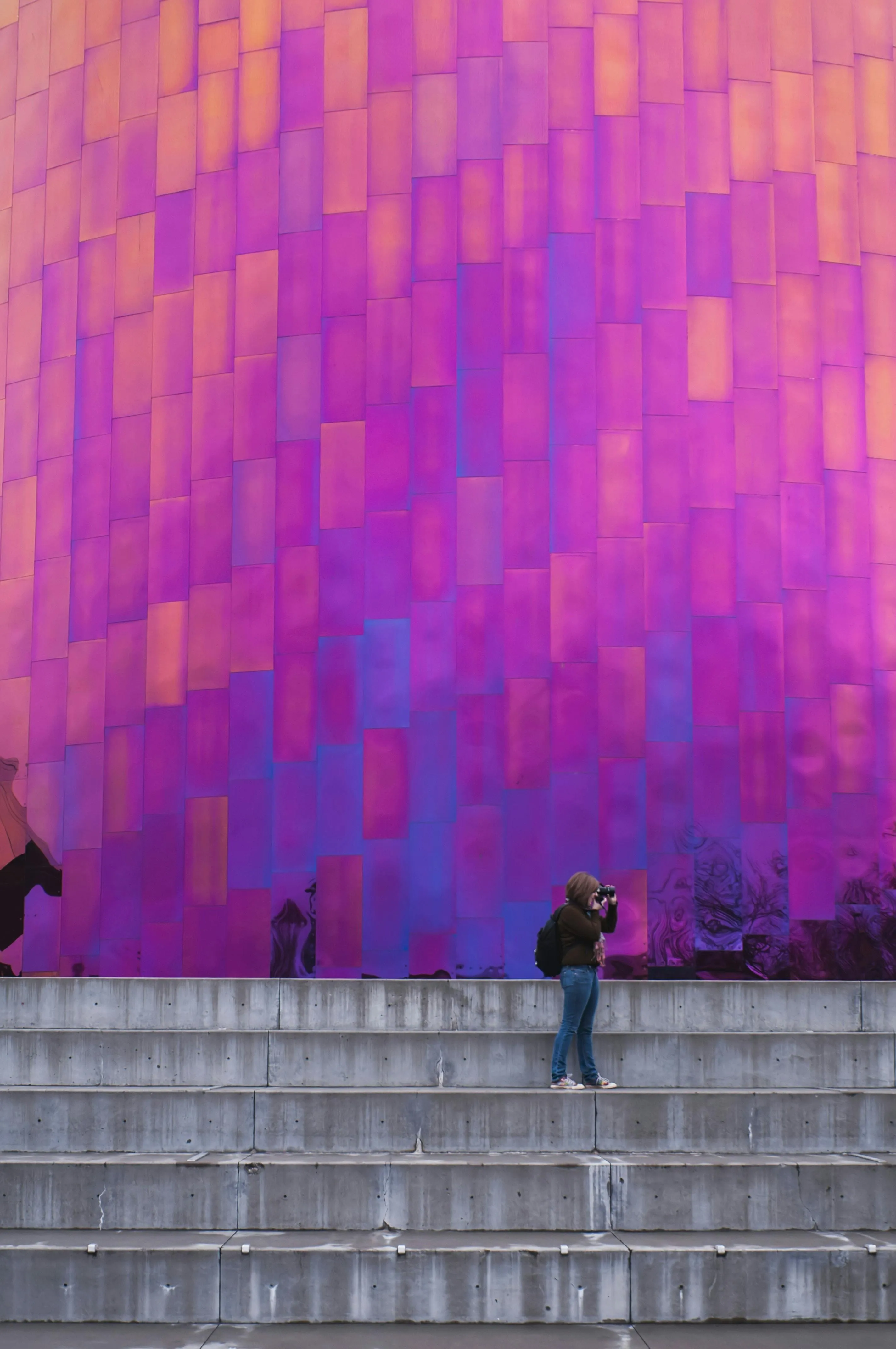 Colourful abstract building wall with purple pink panels