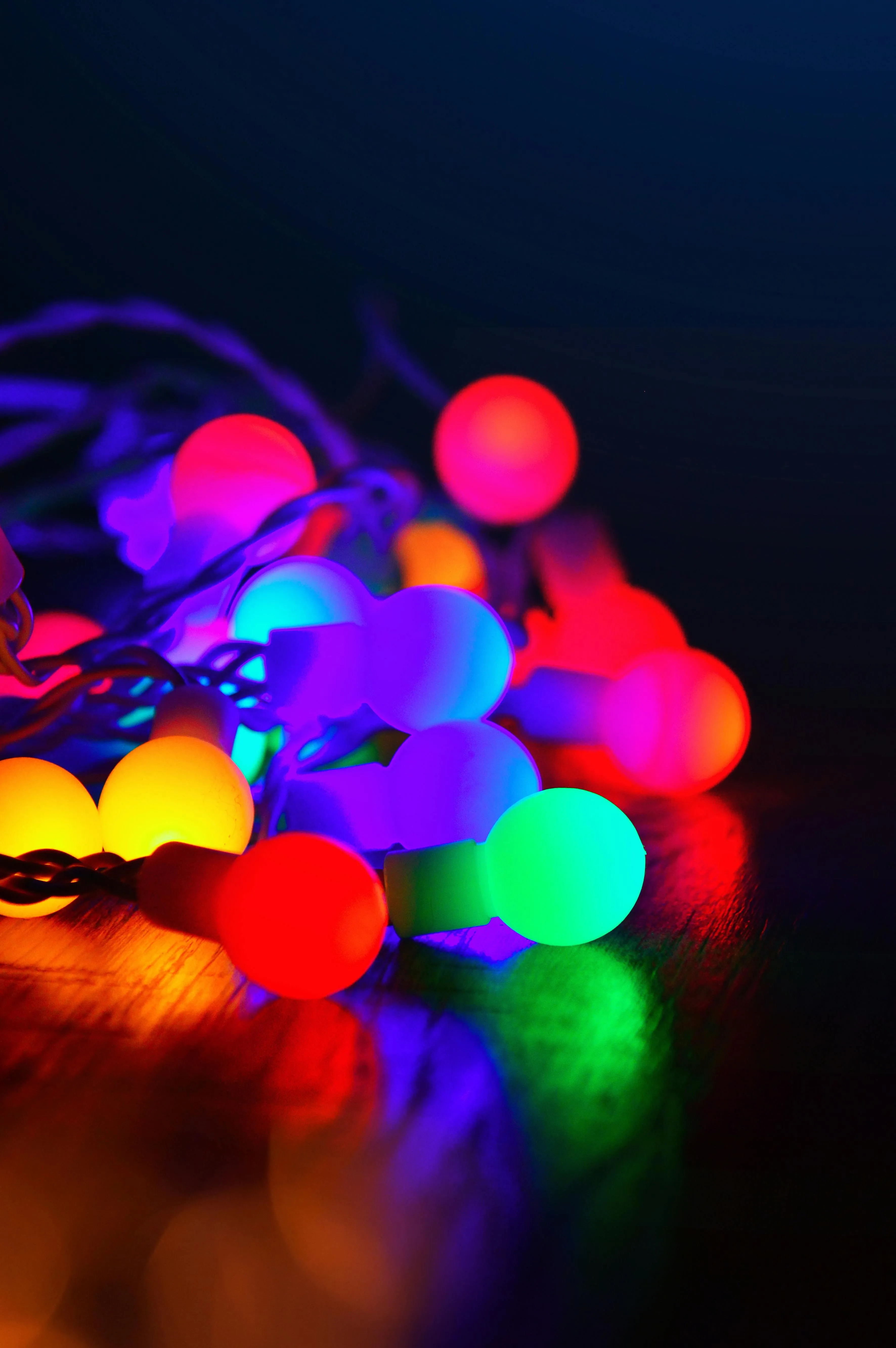 Colourful blurred holiday lights glowing in the dark image