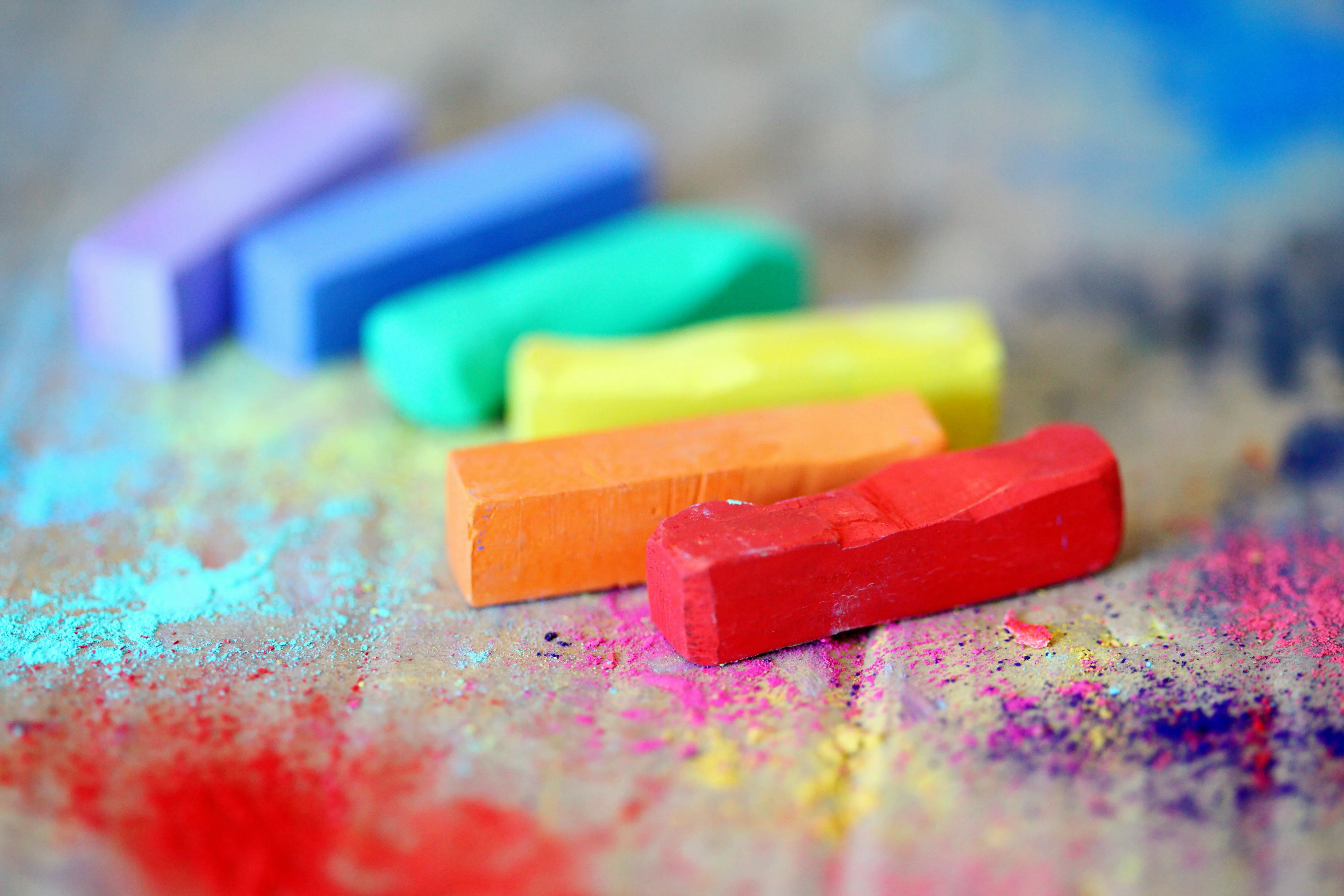 Colourful chalk sticks with powders on the surface Wallpaper