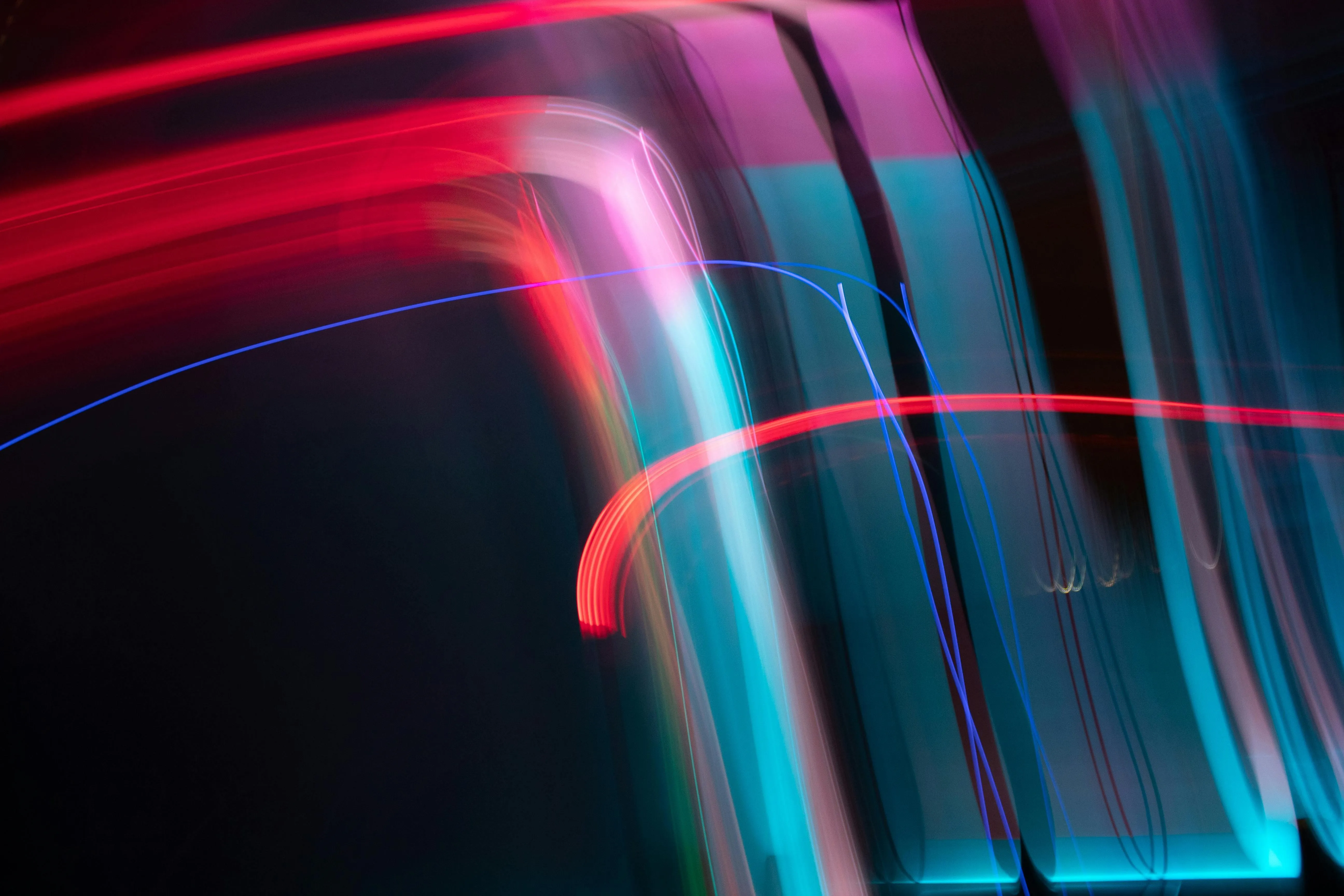 Colourful light trails in motion blur on a black background