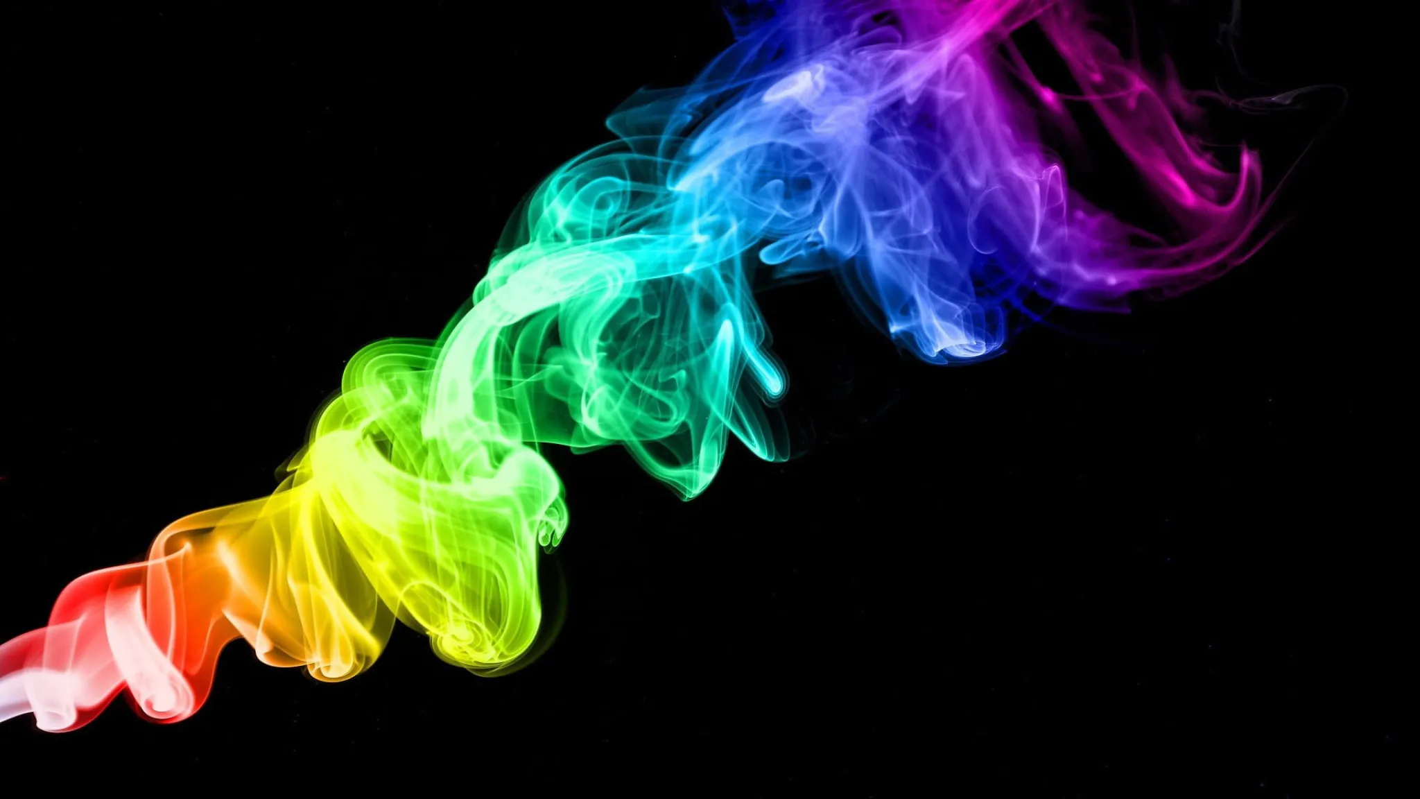 Colourful smoke wave on a black background in rainbow tones