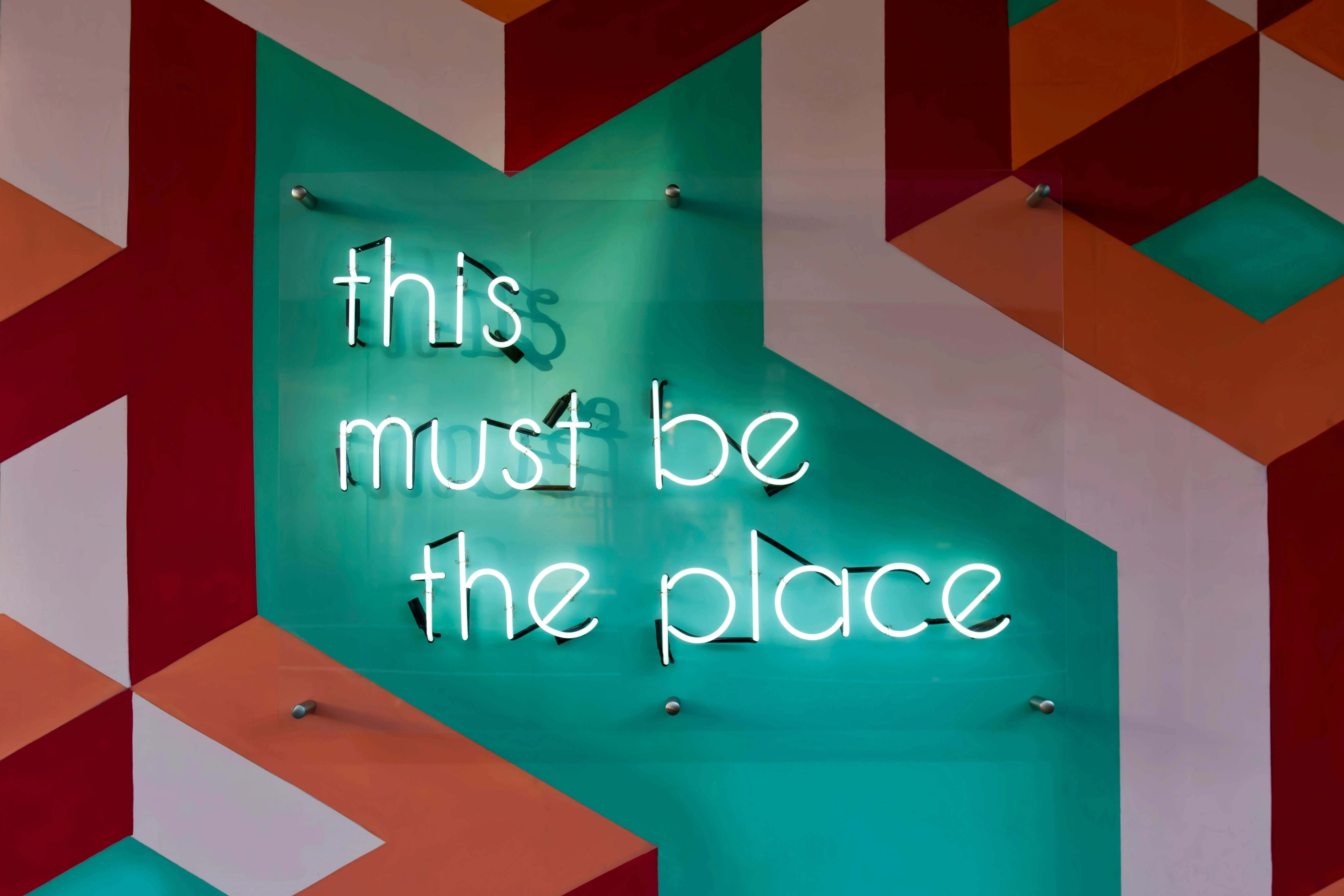 Colourful wall art with text this must be the place visible